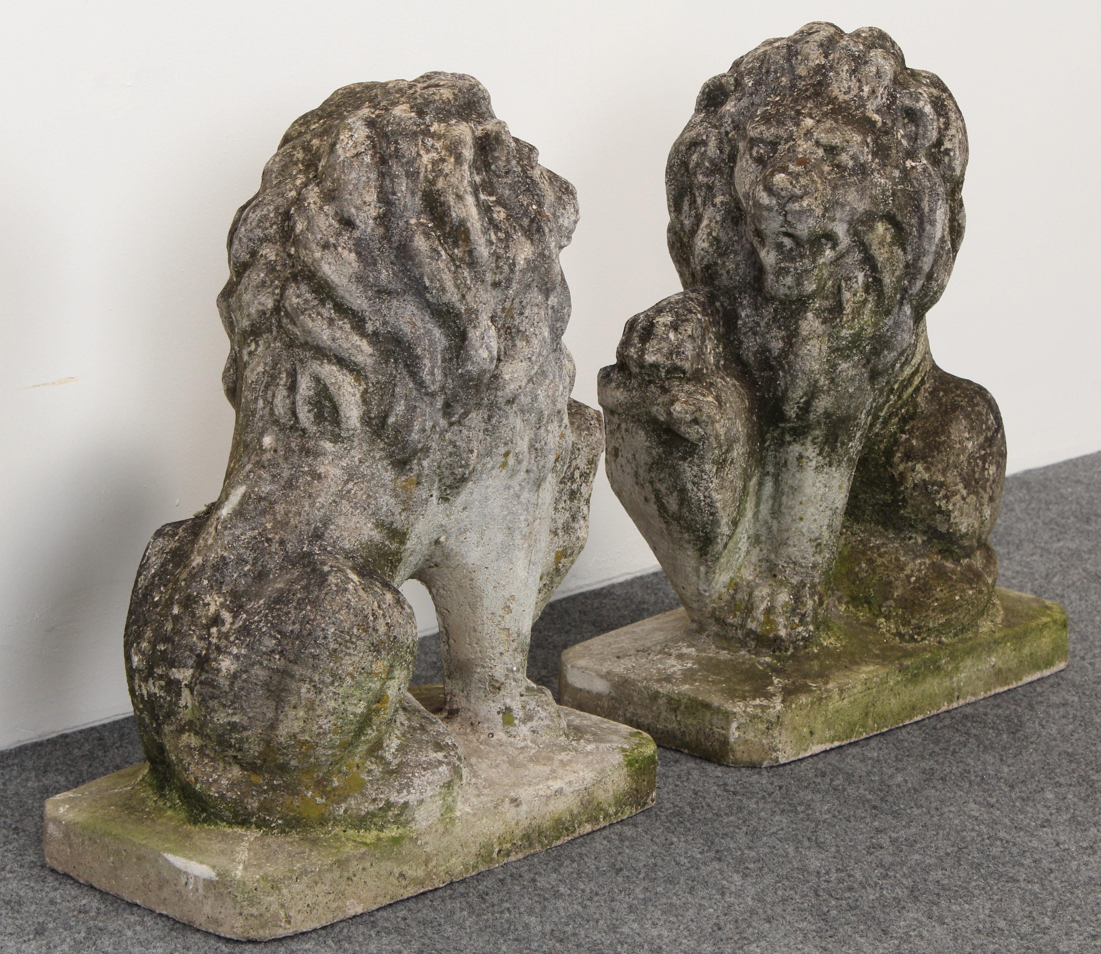 A pair of decorative cast stone seated lion garden statues, 1950s. Great patina with old growth lichen and moss covered surface. Each lion weighs approximately 79 lbs. 

 