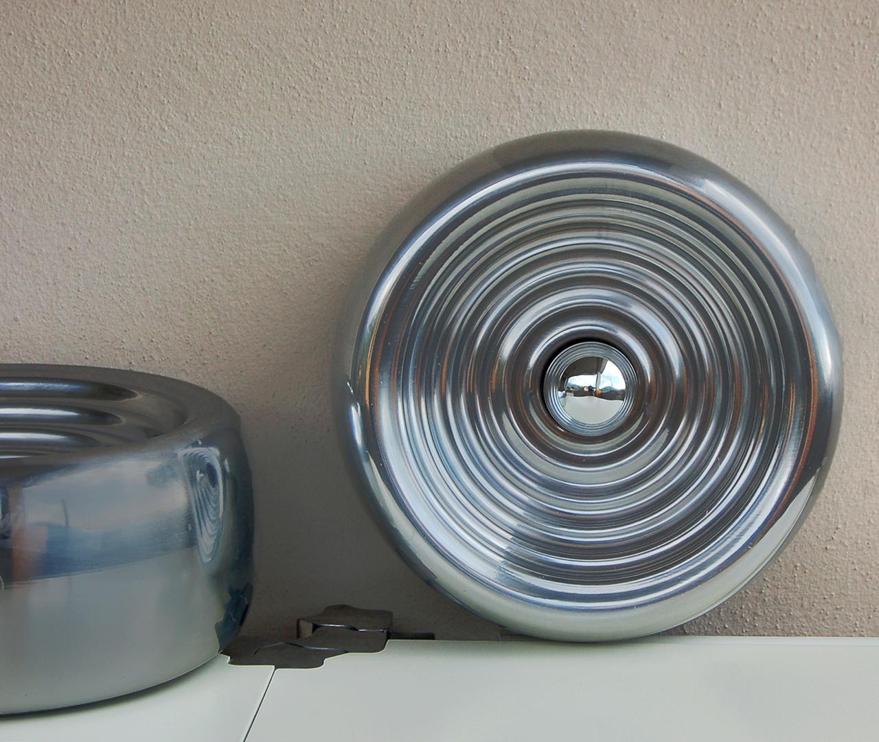 Set of two Padina wall or ceiling lamps by Achille and Pier Giacomo Castiglioni for Flos. 
Thanks to the corrugated polished aluminium, the lamp emits a particular reflected light that multiplies in a series of concentric circles 
Very good