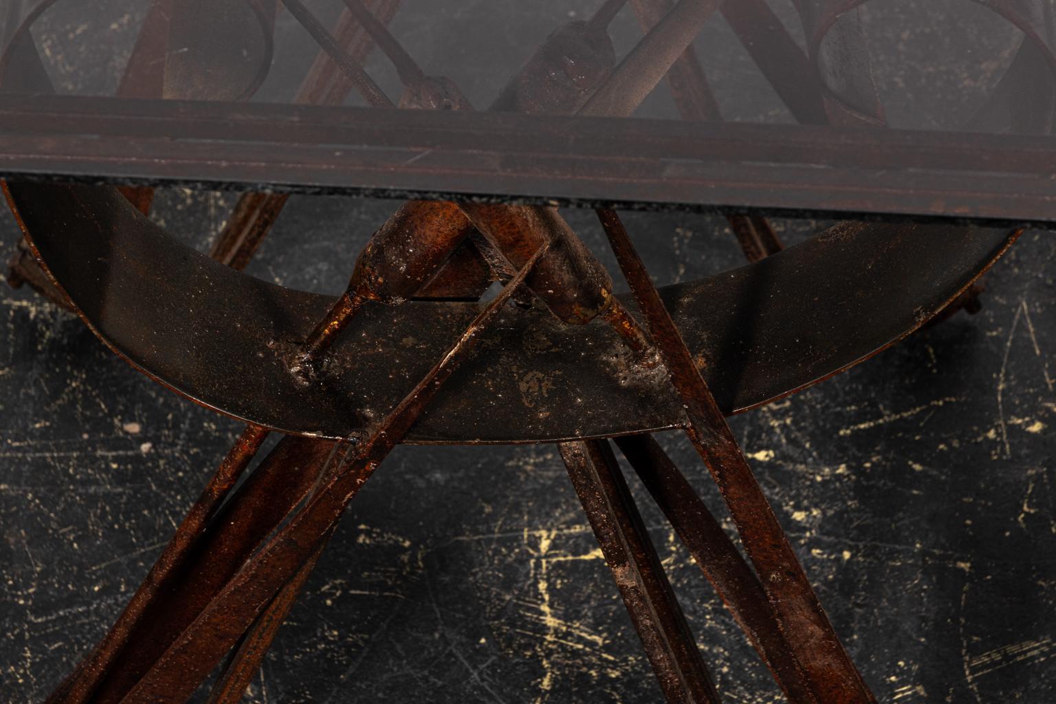 Pair of cat tail iron side tables with black glass tops. Please note of wear consistent with age including heavy oxidation and a distressed finish to the iron base.