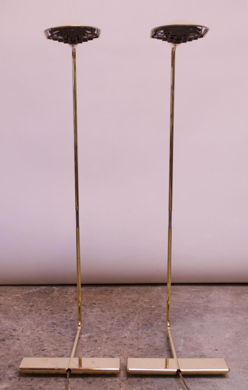 Cedric Hartman adjustable floor lamps with swiveling shades and pivoting arms, circa 1970s. Additionally, the height is adjustable by raising / lowering the stem, and Hartman's signature Lucite dimmer / on and off switch is fully intact. Pair