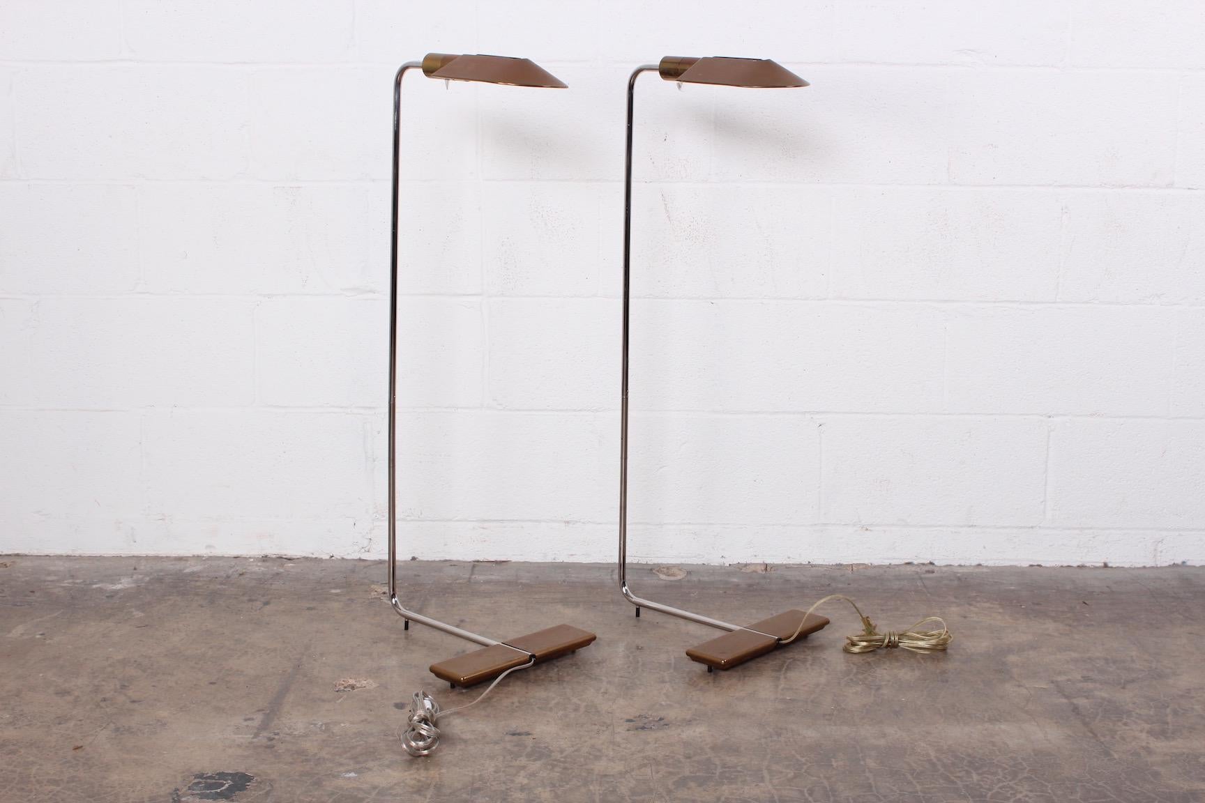 A pair of chrome and patinated brass floor lamps by Cedric Hartman.