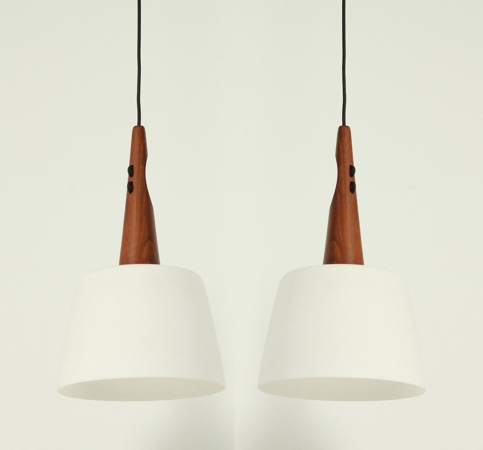 Pair of swedish ceiling lamps in teak and white opaline glass with matt finished from 1960's.