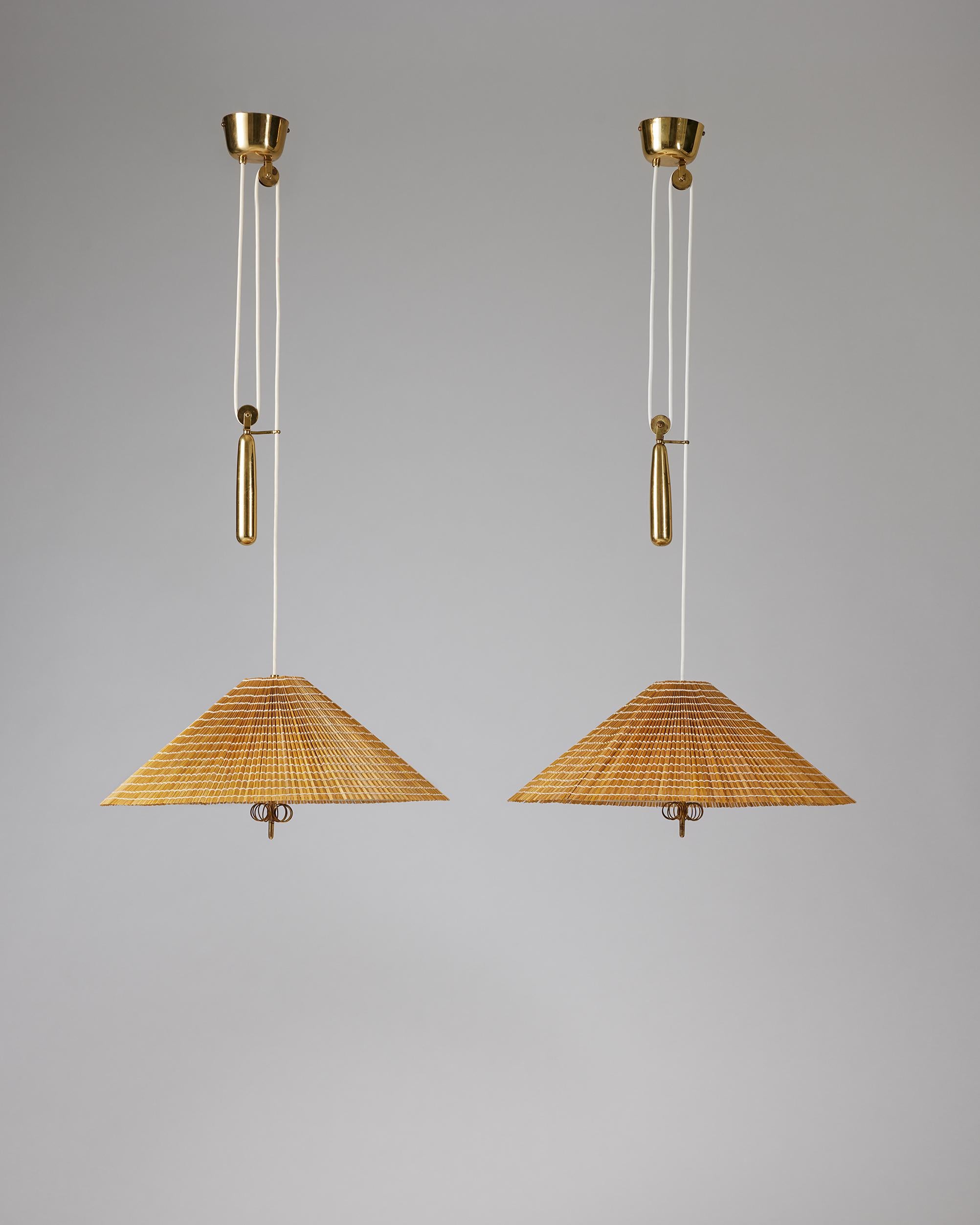Pair of ceiling lamps model A1967 designed by Paavo Tynell for Oy Taito,
Finland, 1940s

Brass, glass and slatted wood shade.

Stamped.

H: 180 cm
H of shade: 31 cm
W: 52 cm.