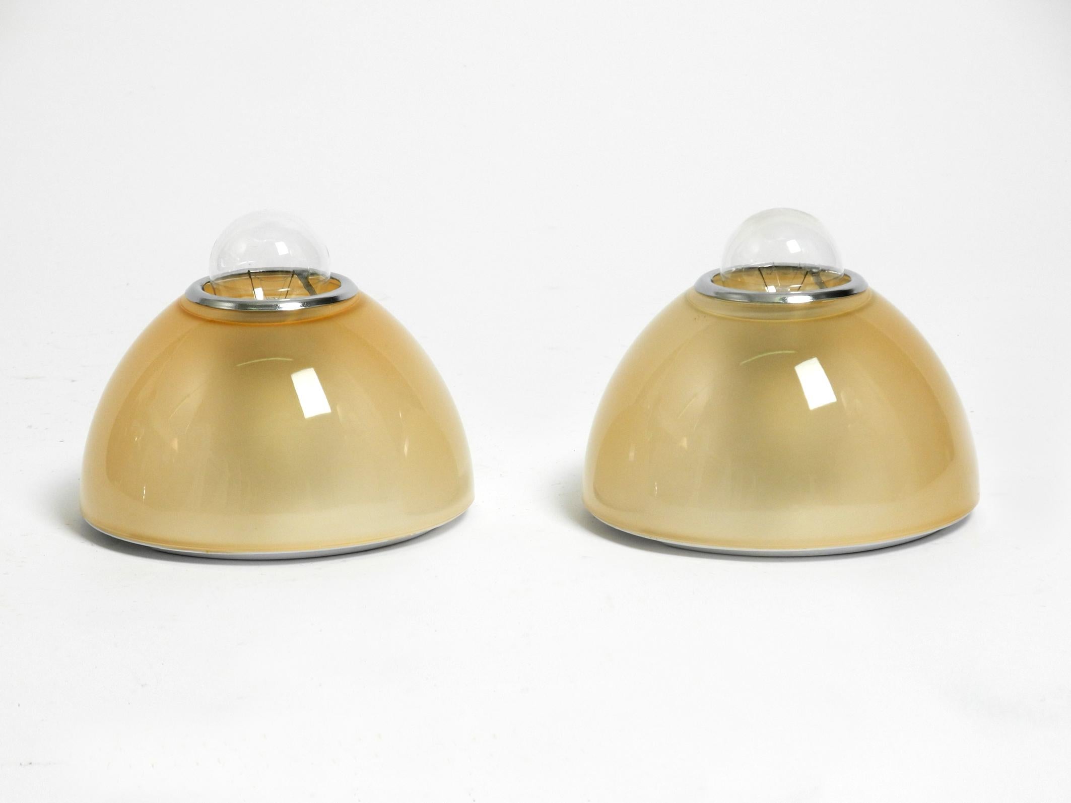 Pair of original ceiling or wall lamps by Ernesto Gismondi for Artemide model Tilos from 1993. He was a member of the influential Memphis design movement,
These Italian classics from the 90s are no longer being built.
Can be used beautifully as