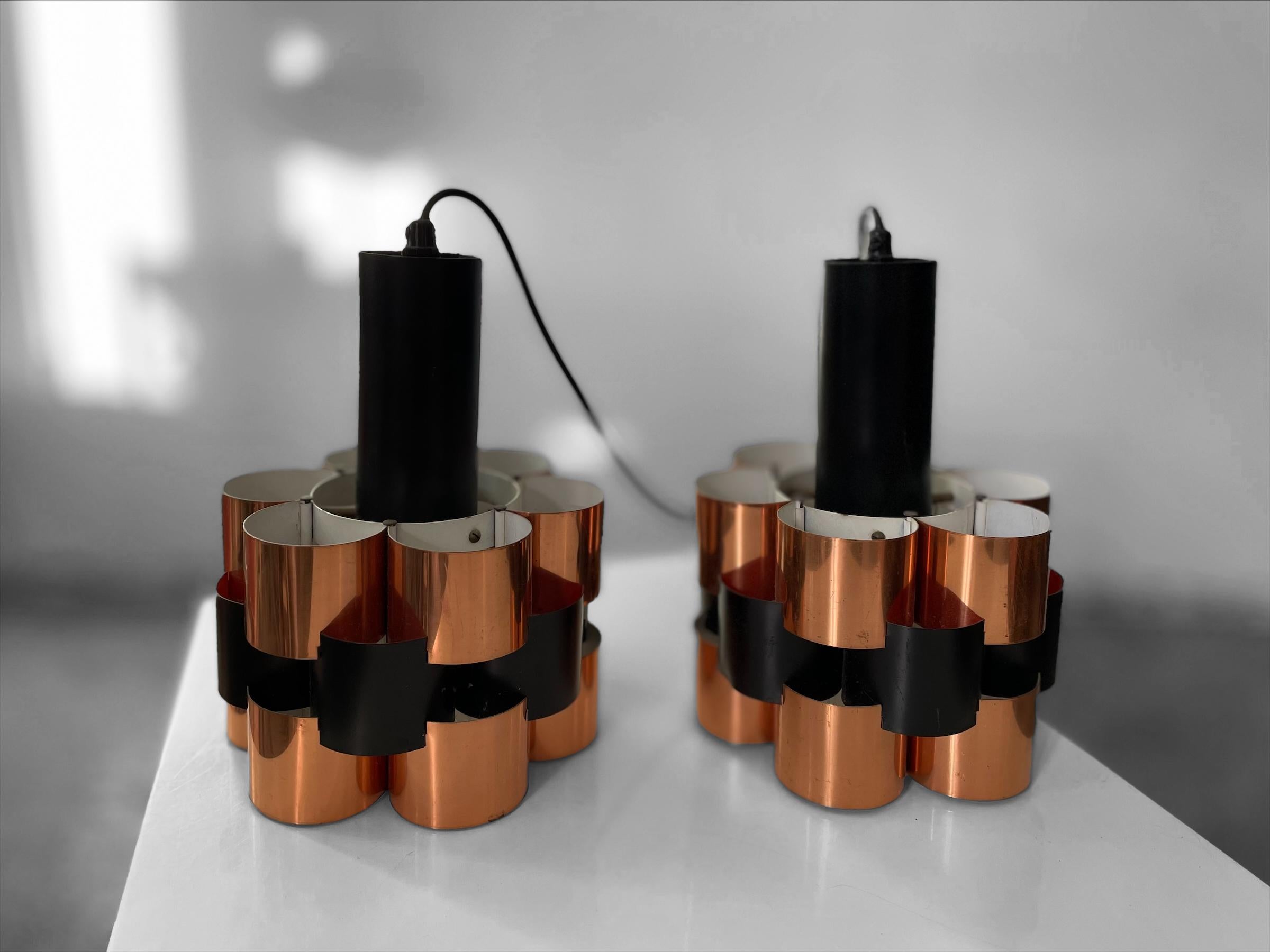 A pair of ceiling pendants in of cobber and black lacquered metal by Werner Schou from the 1960s.