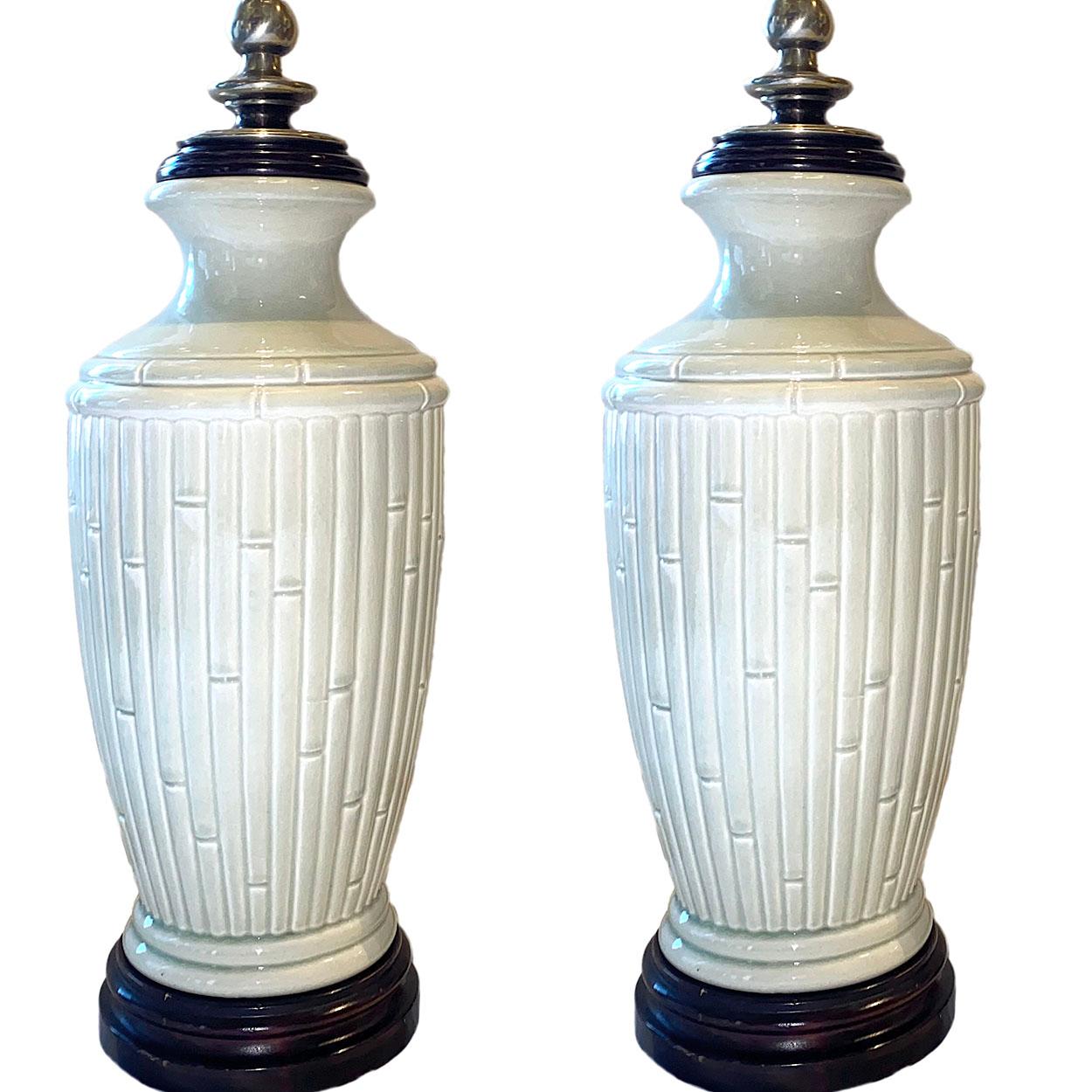 A pair of circa 1960's French table lamps with a bamboo design on the glazed porcelain body.

Measurements:
Height to shade rest: 31