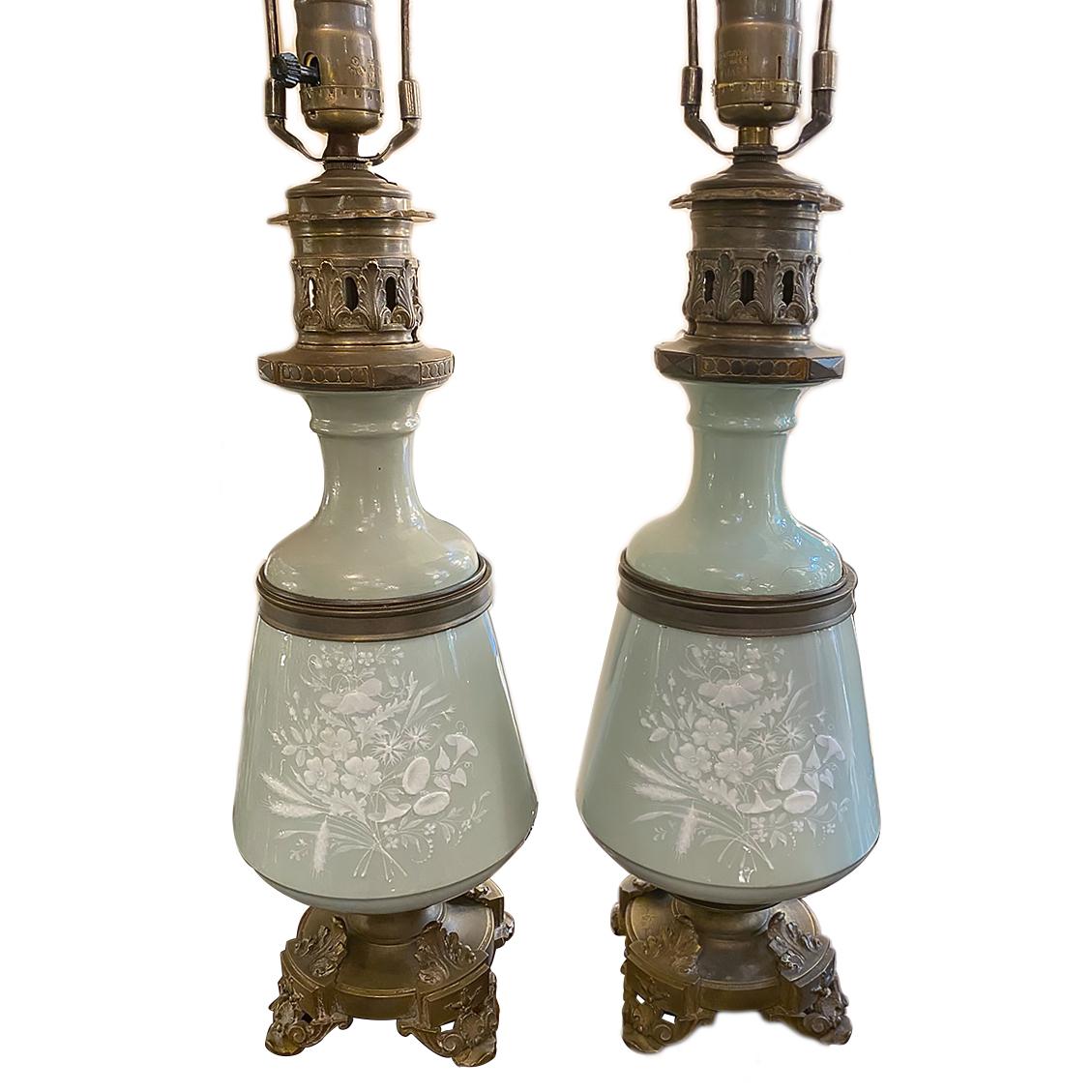 A pair of turn-of-the-century French celadon table lamps with floral decoration, bronze bases and fittings.

Measurements:
Height of body: 17.5
