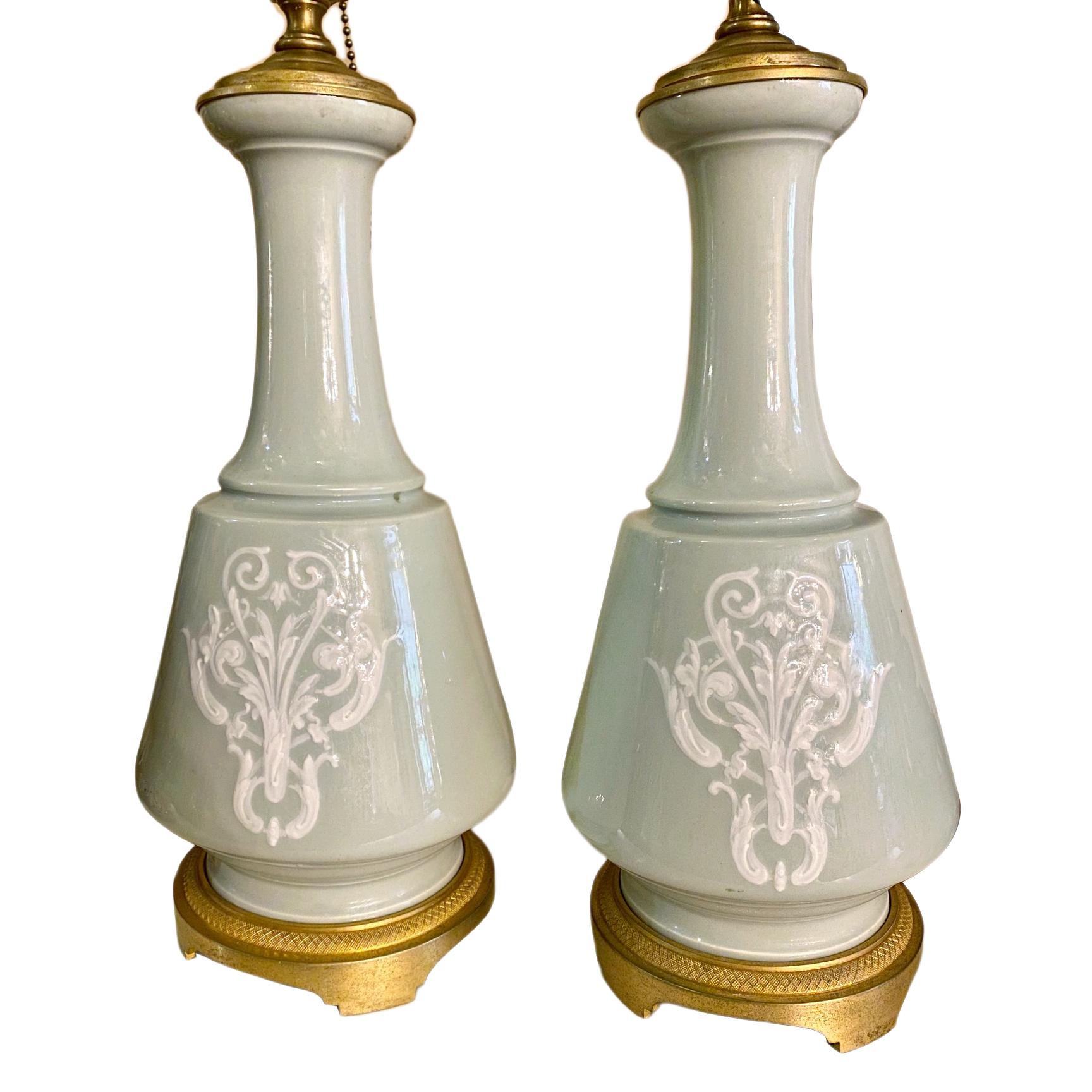 A pair of French circa 1900s celadon table lamps with etched bronze bases.

Measurements:
Height of body: 14