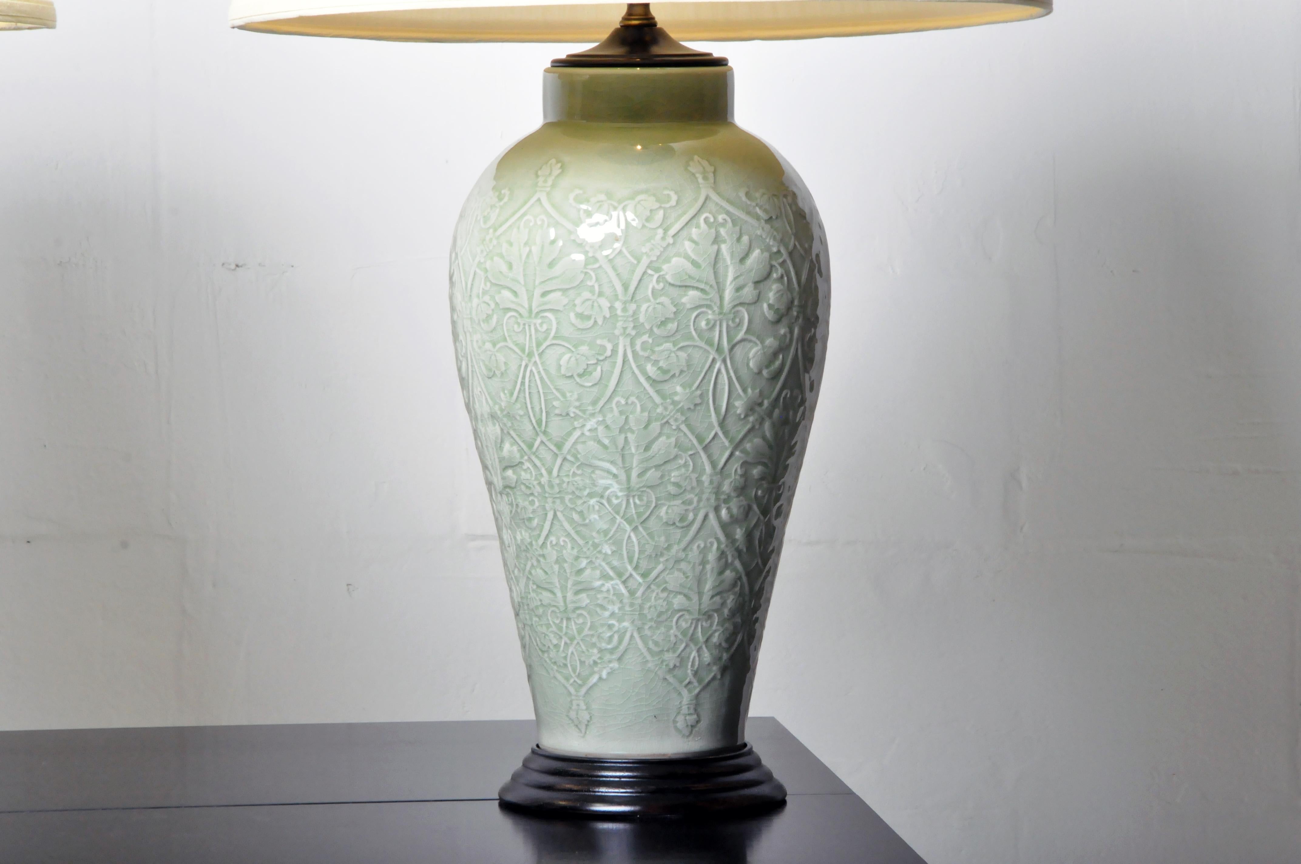 These green celadon vases were from Thailand and were converted to table lamps for use in the United States, c. 21st Century. The price is for the pair.