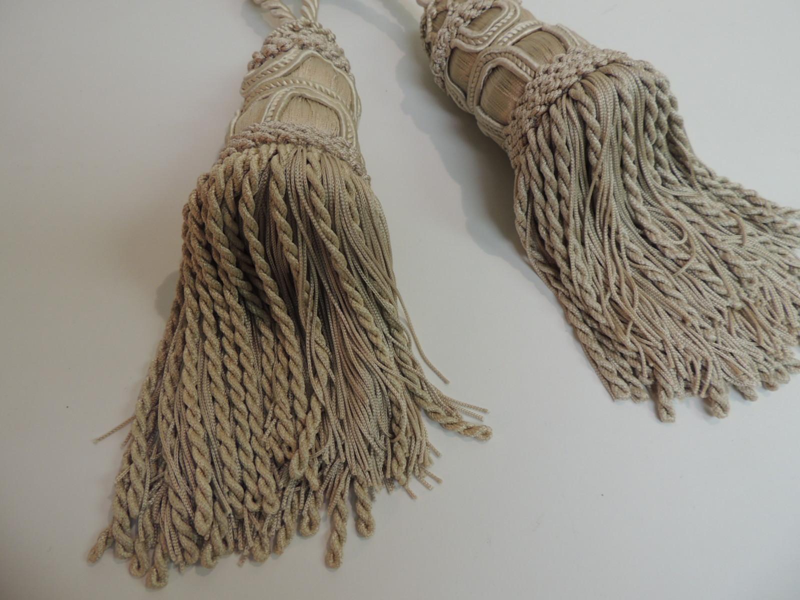 Pair of celadon green silk tassels. Silk tassels with curtain tie back ropes.
 Rounded woven tassels 10 inches long.
Britex Fabrics in San Francisco
Size: 29 x 3 x 10.