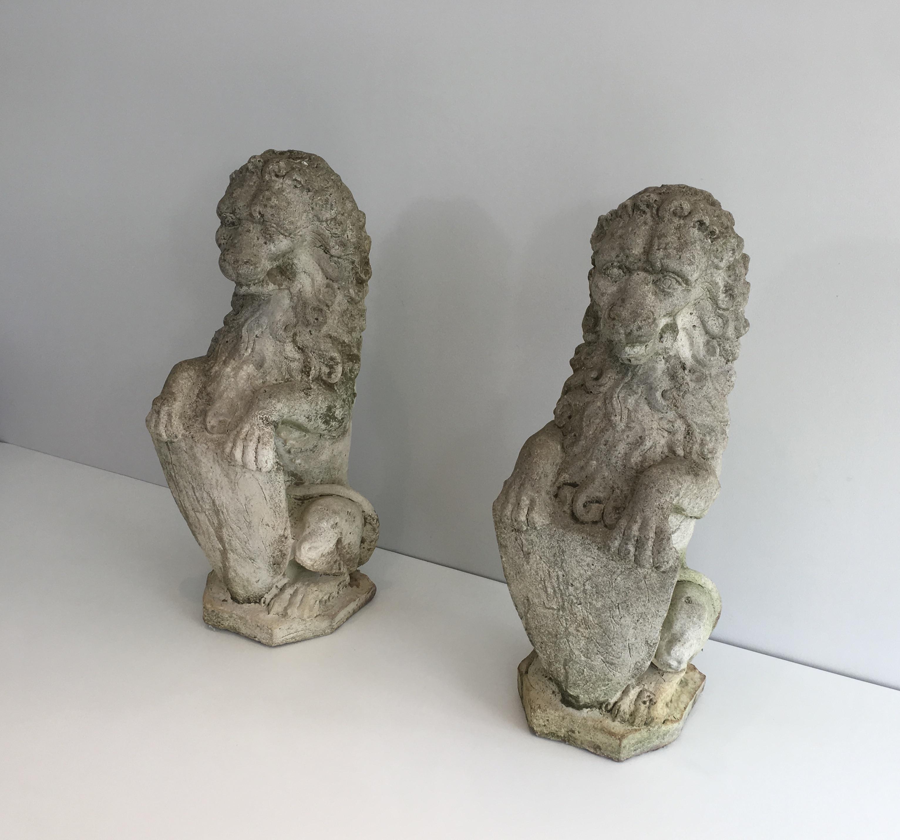 This pair of decorative lions standing with a shield are made of cement lions. This is a French work, circa 1950.