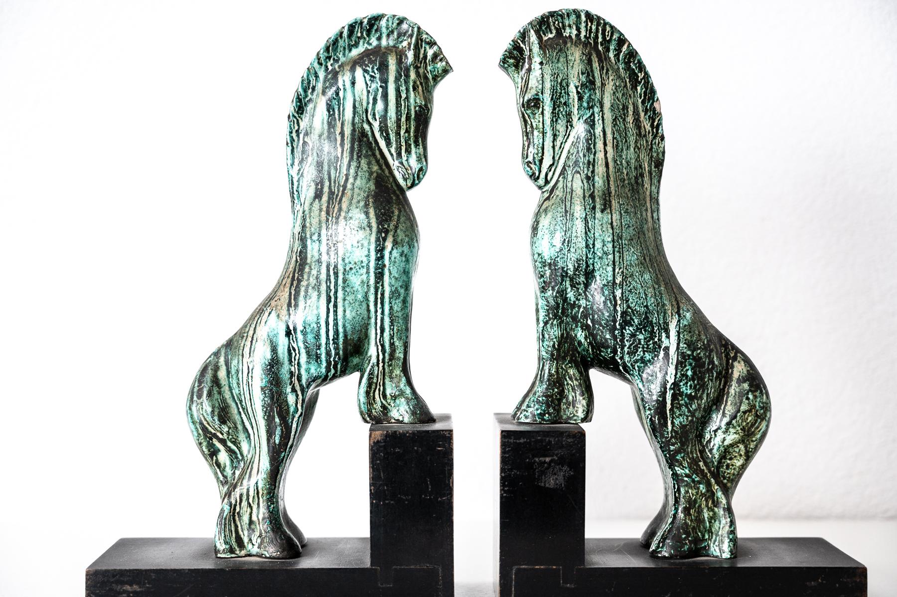 A pair of bookends by  Guido Cacciapuo featuring stoneware horses enameled in green. 
Signature engraved on horses: G. Cacciapuoti
made between  1930-1940.
Italy (priced for the pair)
Bibliography: AA.VV. Le ceramiche di Cacciapuoti da Napoli a