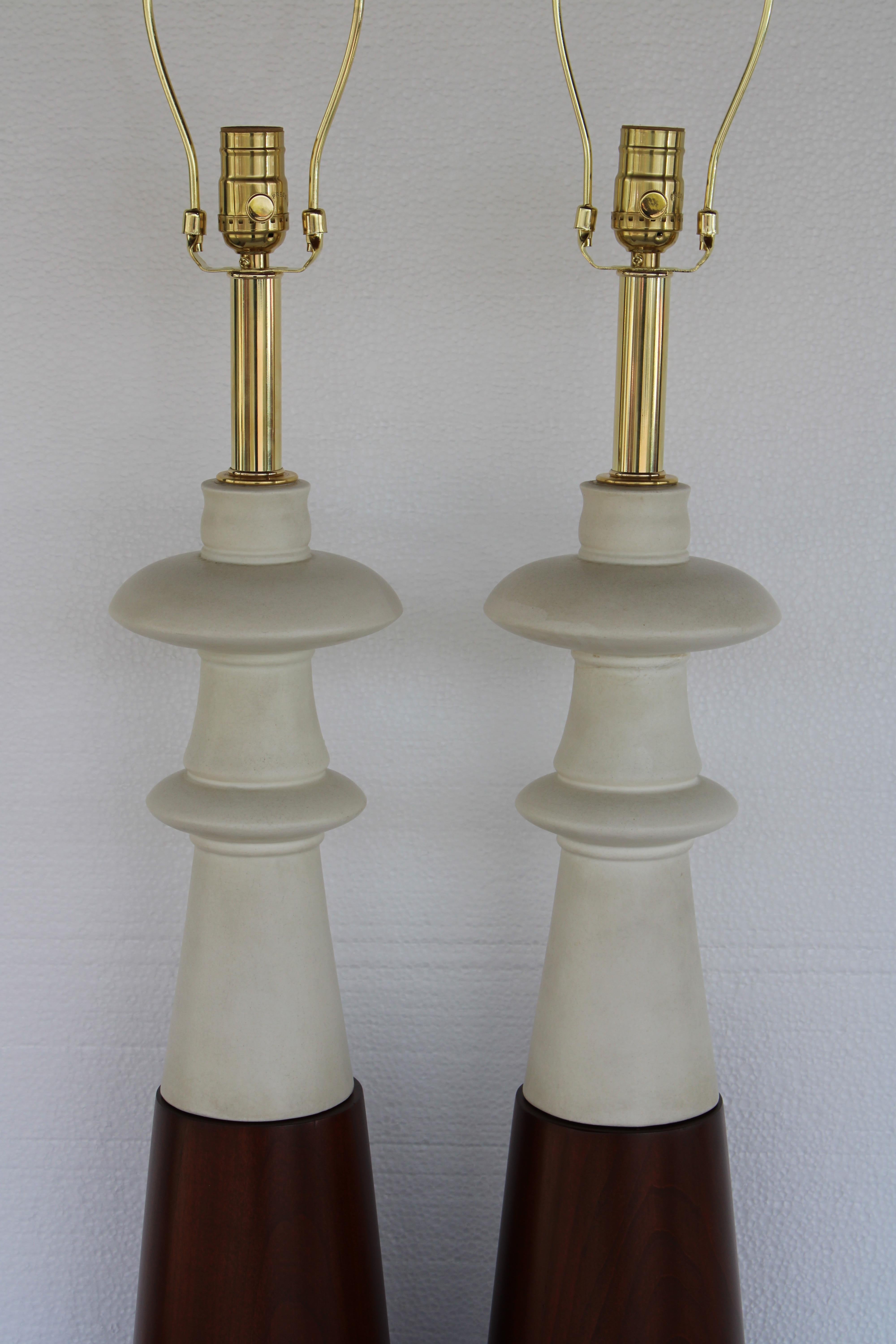 Pair of ceramic and wood table lamps. Lamps measure 26.5