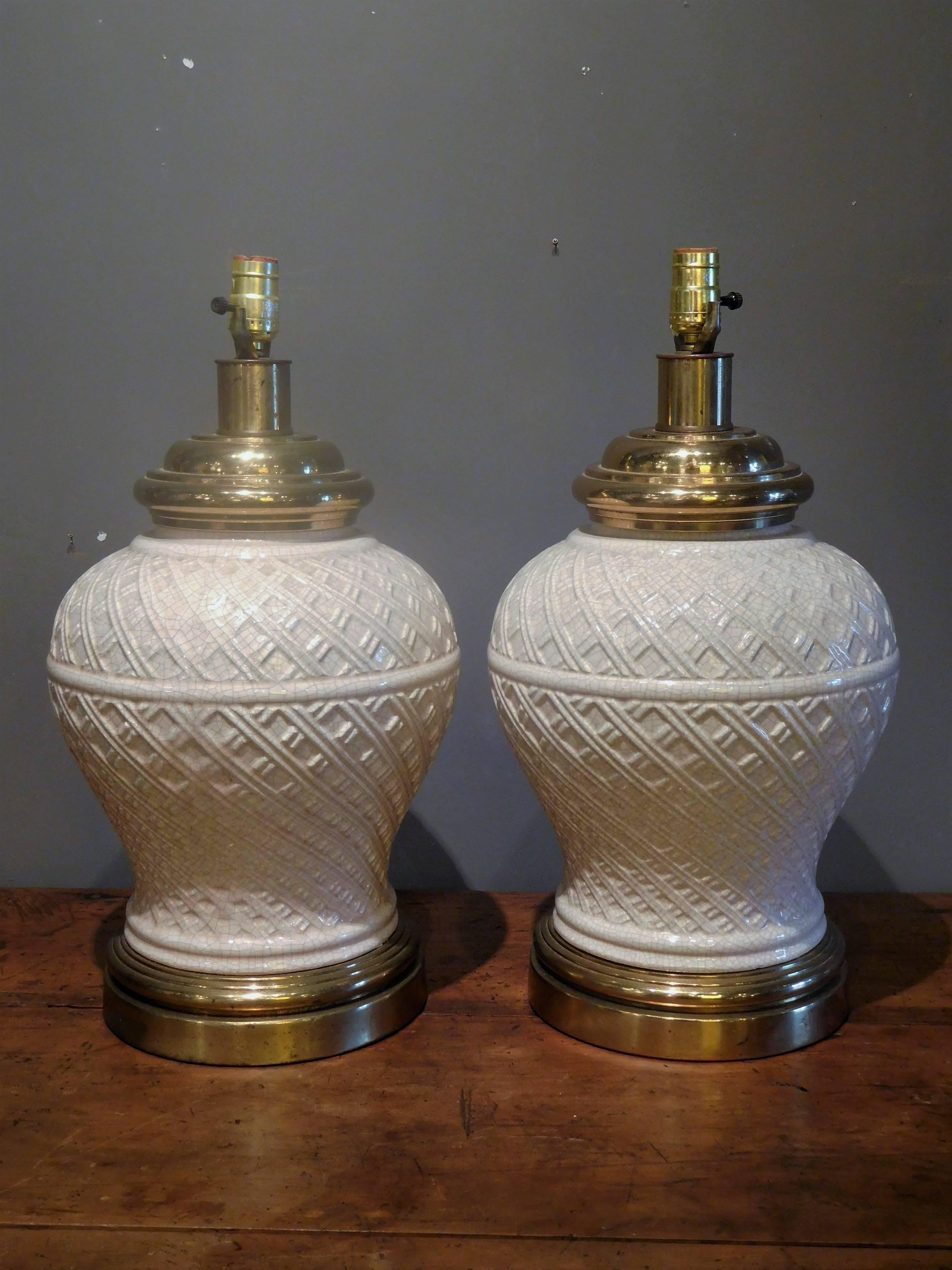 These ceramic and brass baluster-shaped lamps are attributed to the Paul Hanson Lighting Company, circa 1955. Inspired by traditional Chinese vessels, but upgraded in a modern basket-weave pattern, these lamps are mounted on brass plinth bases and