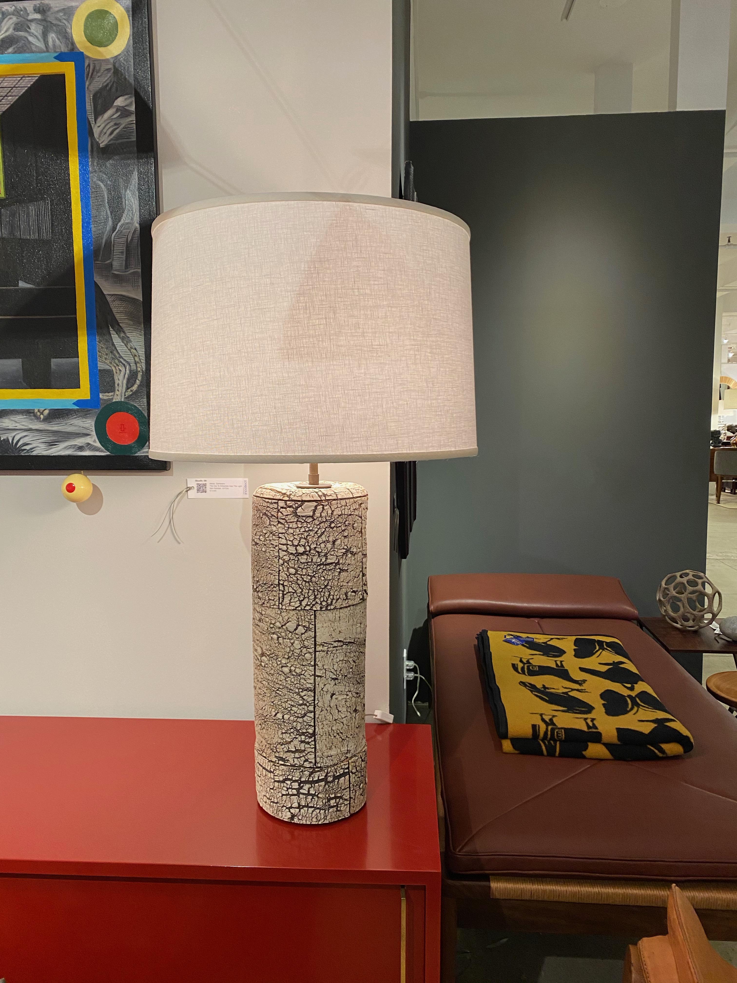 Peter Lane is an American ceramic artist who has exhibited at FOG design and Art Fair and at the Bass Museum of Art. He introduced the birch bark finish in mid-2000s and these lamps were produced a little later. Signed on back. White linen drum