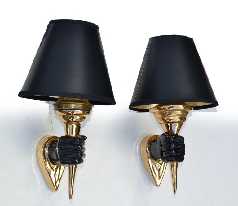 Elegant neoclassical pair of ceramic hand sconces, wall lamps in black & gold finish by Maison Arlus, made in France.
US rewiring and each sconce takes 1 Torpedo light bulbs with max 60 watts, LED work too.
Sold with paper shades in black & gold