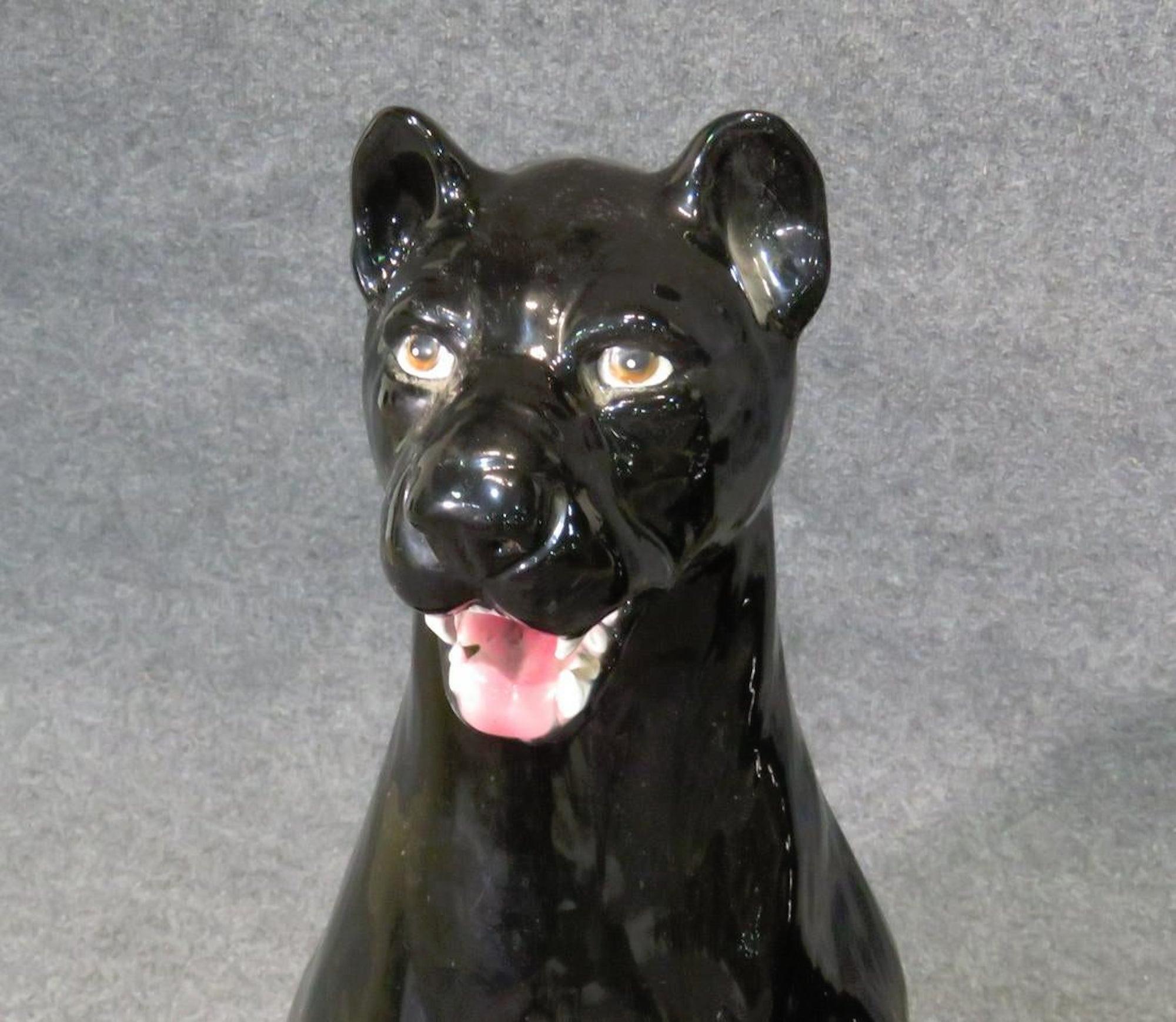 Pair of glazed ceramic sitting panthers in black.
(Please confirm item location - NY or NJ - with dealer).
 