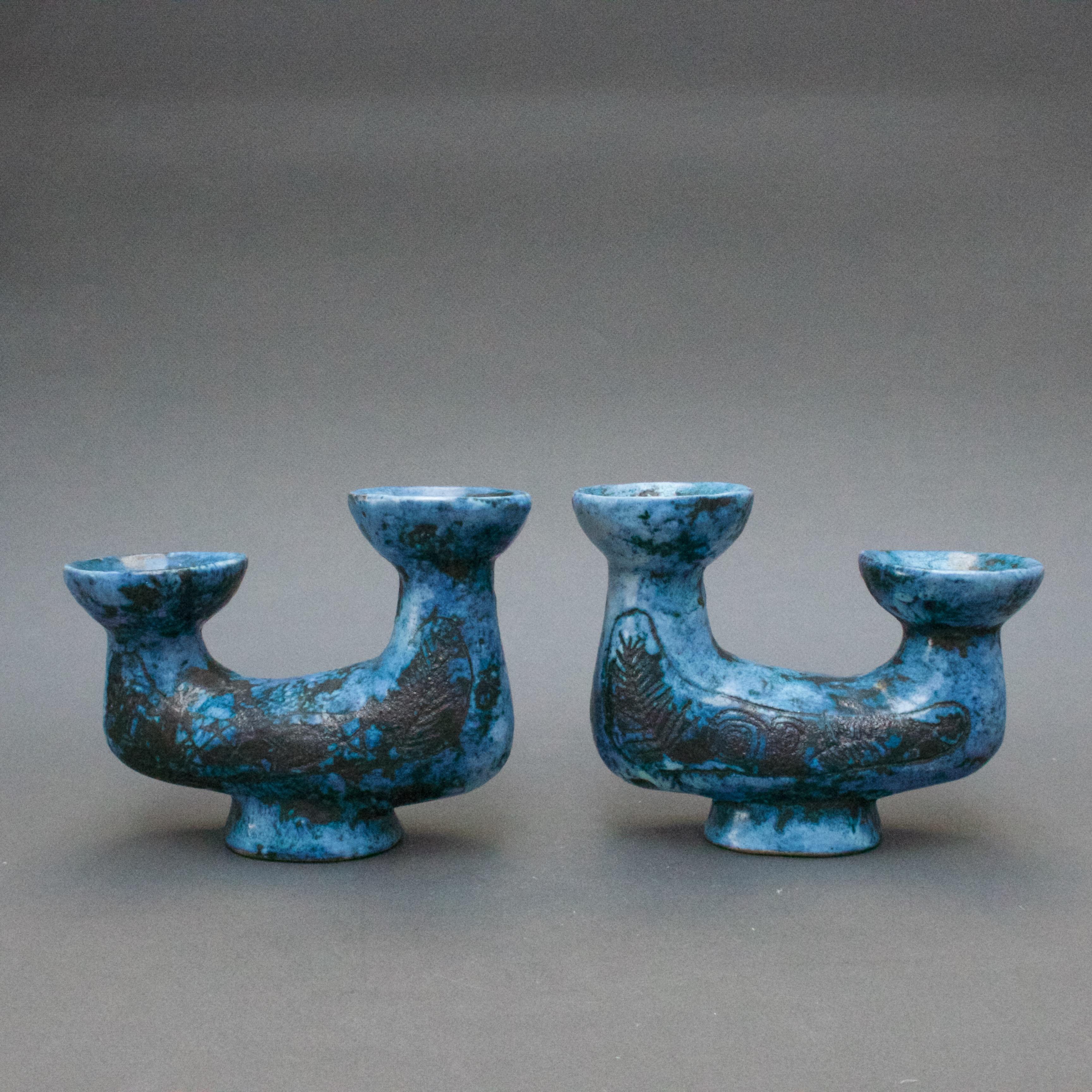 A pair of classic blue ceramic candle holders with motif by Jacques Blin (1920-1995), an engineer by trade but with a love for the visual arts. Blin has an immediately recognisable style characterised by a more or less misty appearance of the glaze