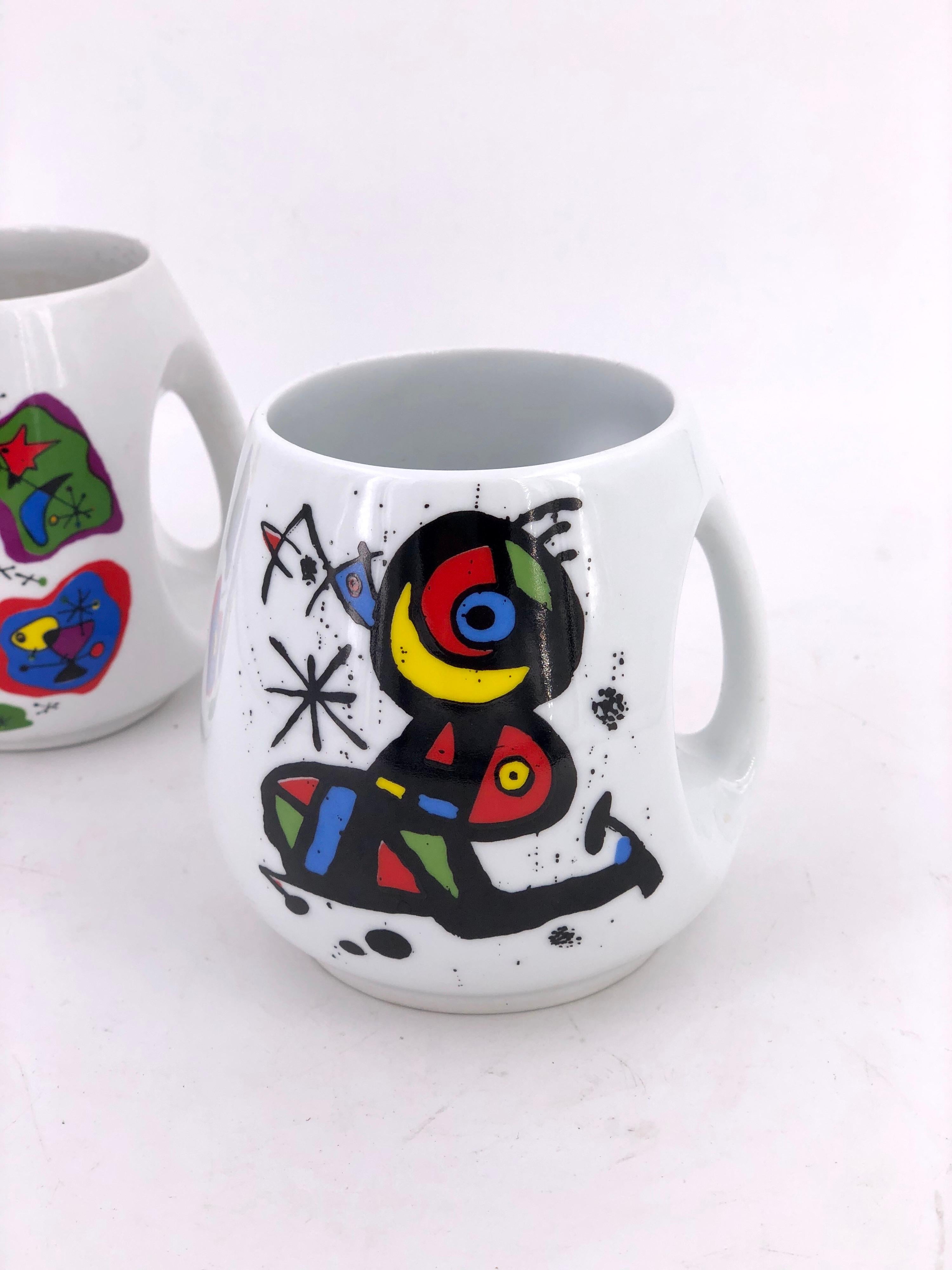 Nice pair of commemorative ceramic coffee mugs by Joan Miro, circa 1980s Barcelona Spain nice condition no chips or cracks, circa 1980s.