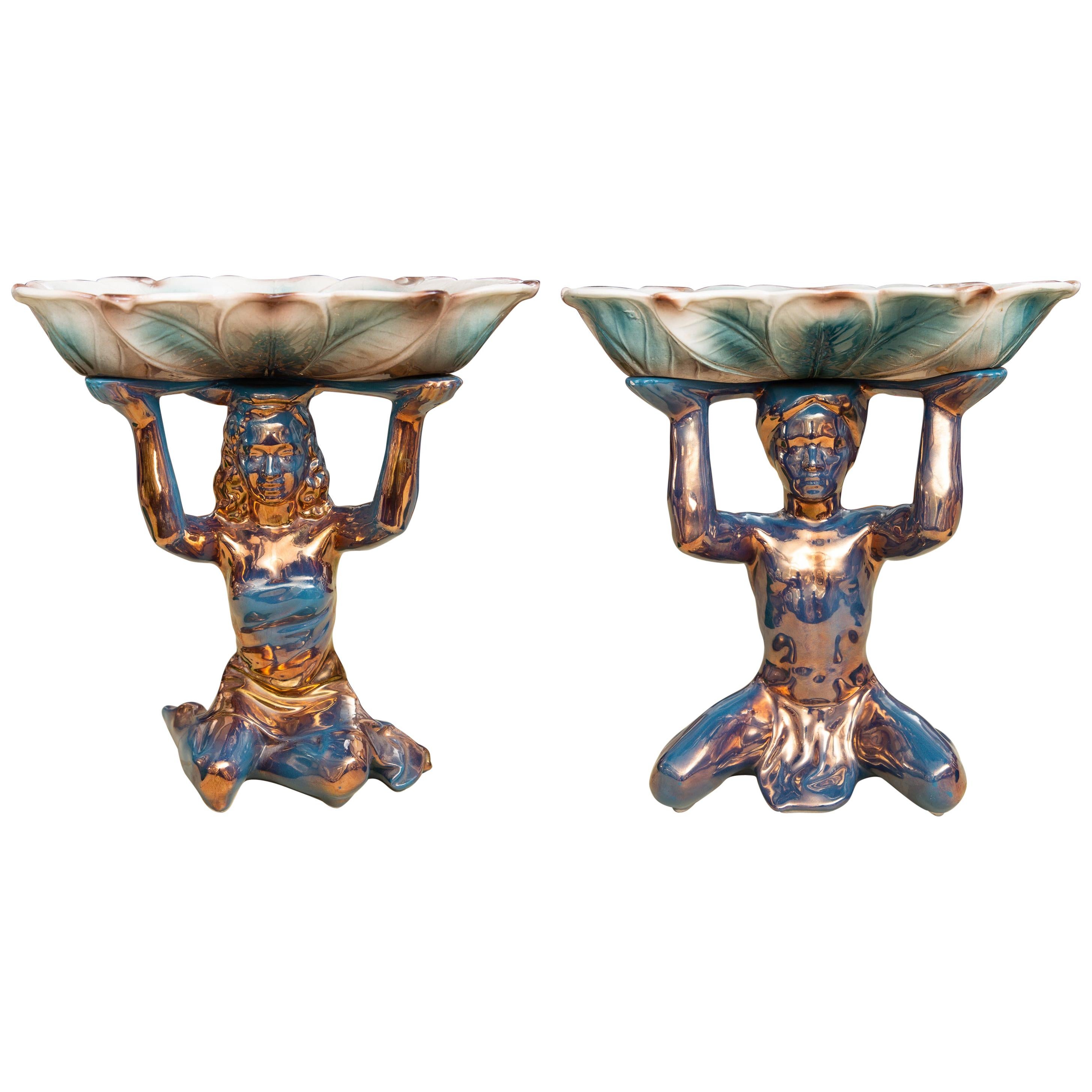 Pair of Ceramic Compotes Depicting Kneeling Figures Holding Shallow Bowls For Sale