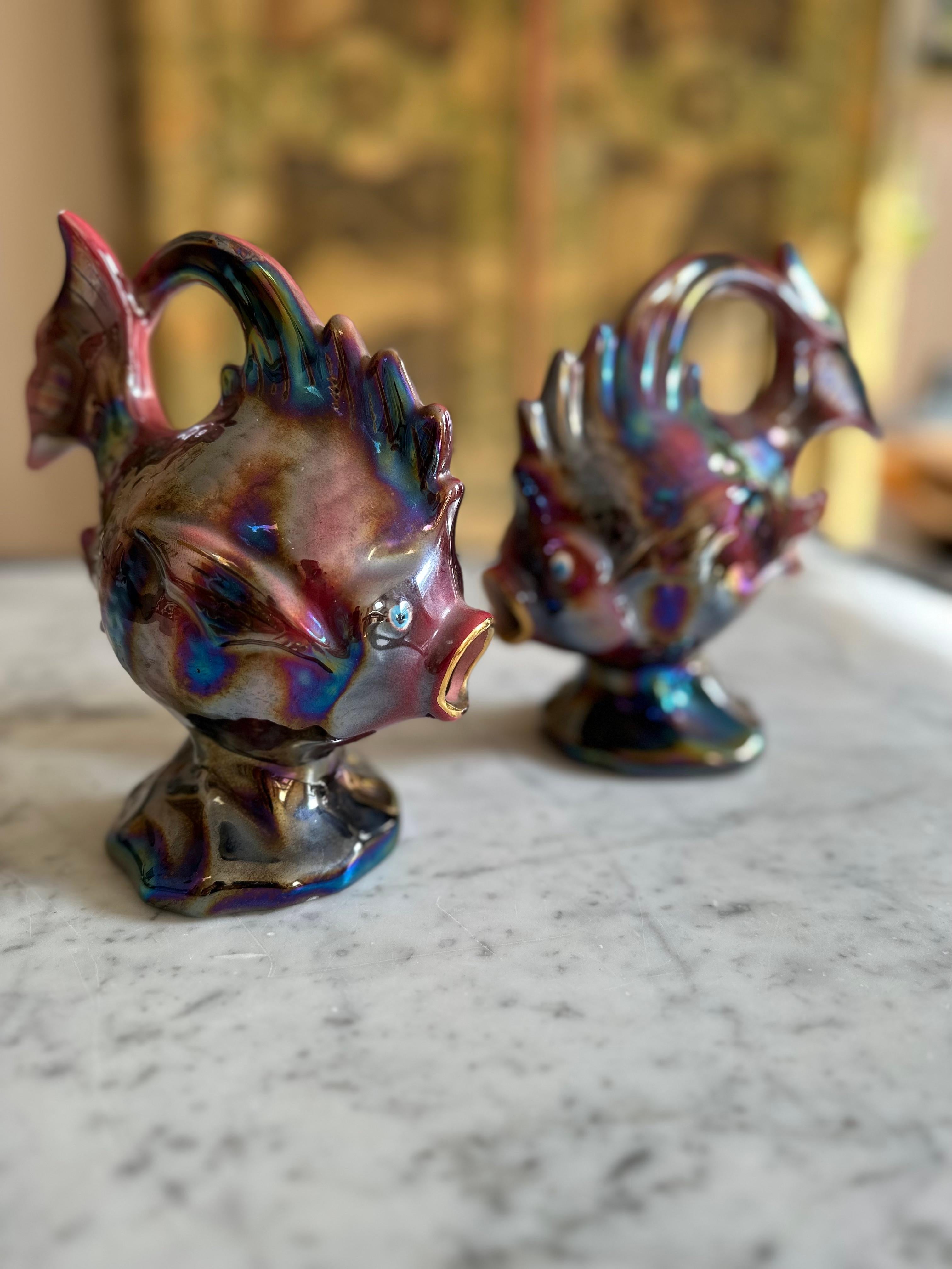 Introducing our delightful Pair of Ceramic Fish Figurines, a charming representation of mid-20th-century artistry from the enchanting city of Monaco, courtesy of Florence Monte Carlo. These whimsical fish come together as a playful couple, exuding a