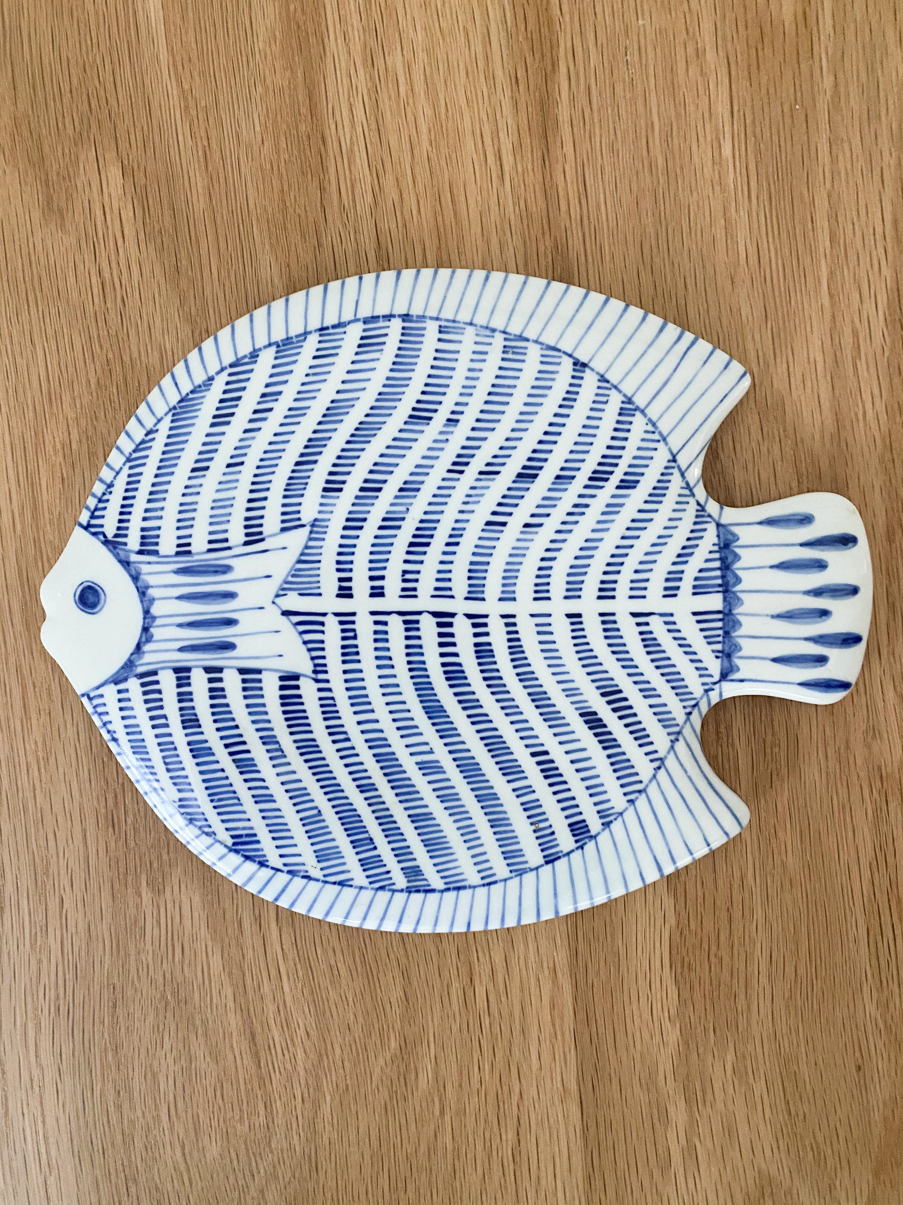 Vintage pair of hand painted ceramic fish plates. Beautiful blue painted details on white ceramic. Great as table display or as trivets.