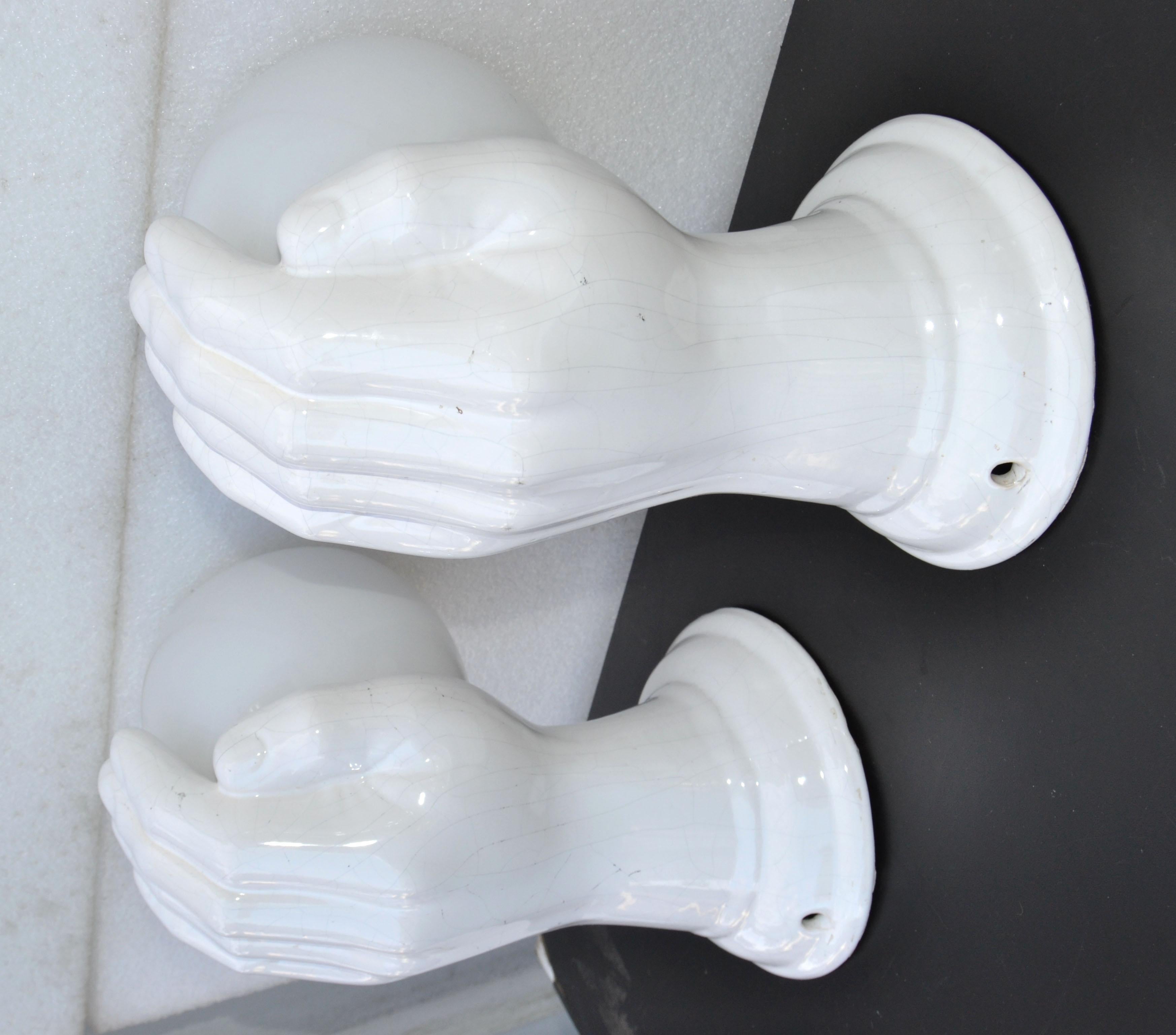 Very elegant pair of white ceramic hand sconces with original Opaline shades, circa 1950.
Takes 1-light 40 watts max bulb.
Wired for US and in working condition.
Measures: Back plate 5 inches. diameter.
 