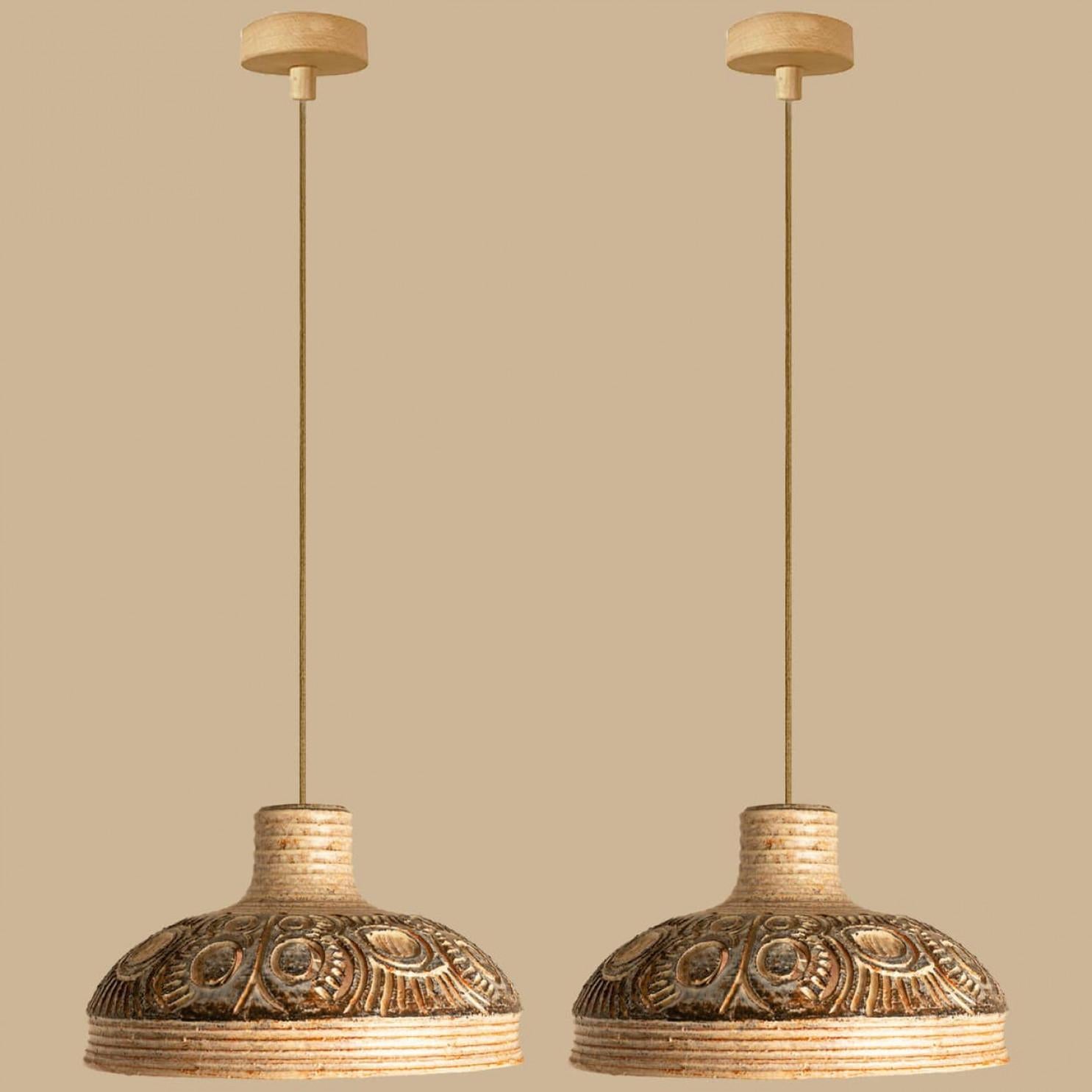A  pair of Ceramic Geometric Pendants by Jette Hellerøe for Axella Denmark, 1960s.

Stylish ceramic pendant light made in Denmark. The lights are made of brown and beige ceramic and have a geometric pattern on it.

A unique statement piece in the