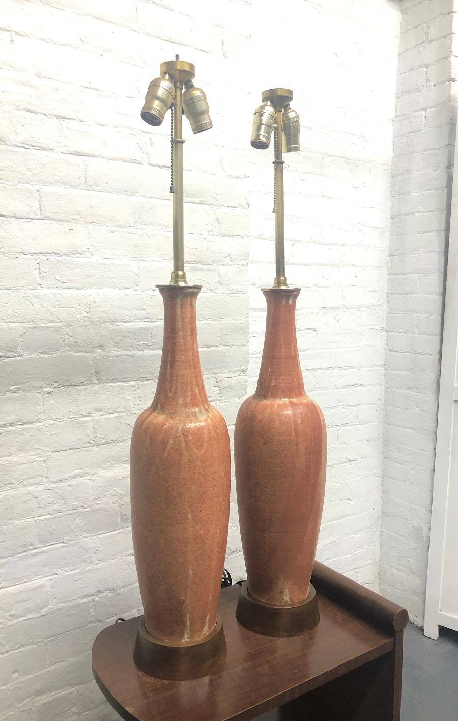 Pair of ceramic Italian lamps by Marcello Fantoni for Raymor. The base of the lamps are walnut.

Measures: 39 height (to top of finial). 
Under socket: 23.25 height. 
Body: 5.25 diameter. 
Base: 5.75 diameter.