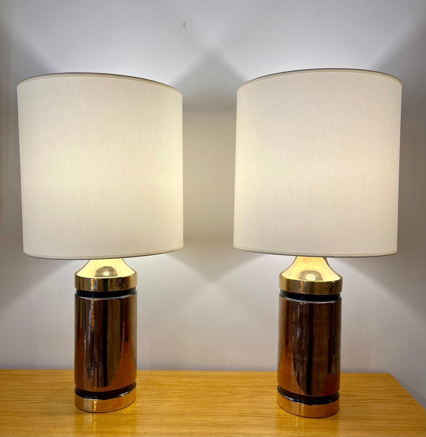 Pair of  ceramic lamps by Bitossi

Pair of glazed ceramic  lamps in shades of gold and copper.
By Bitossi (manufacturer) for Miranda ( Swedish retailer ) 
Italy, 1960

Dimension :

Height ( total - with lampshade ) : 27,55 inches
Height ( ceramic +