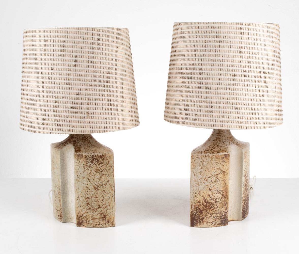 Introducing a remarkable pair of ceramic lamps that effortlessly bridges the realms of art and design. Designed by the visionary Haico Nitzsche and meticulously produced by the renowned Søholm Stentøj pottery studio in Bornholm, Denmark during the