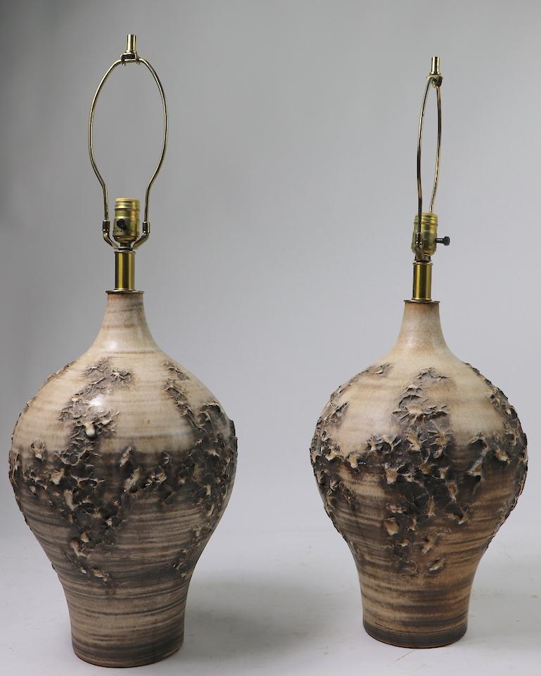 Impressive pair of ceramic table lamps designed by Lee Rosen for design techniques. Both are in excellent, original, undamaged and working condition, both are signed. Hard to find in pairs, stunning midcentury period pottery lamps. Height to top of