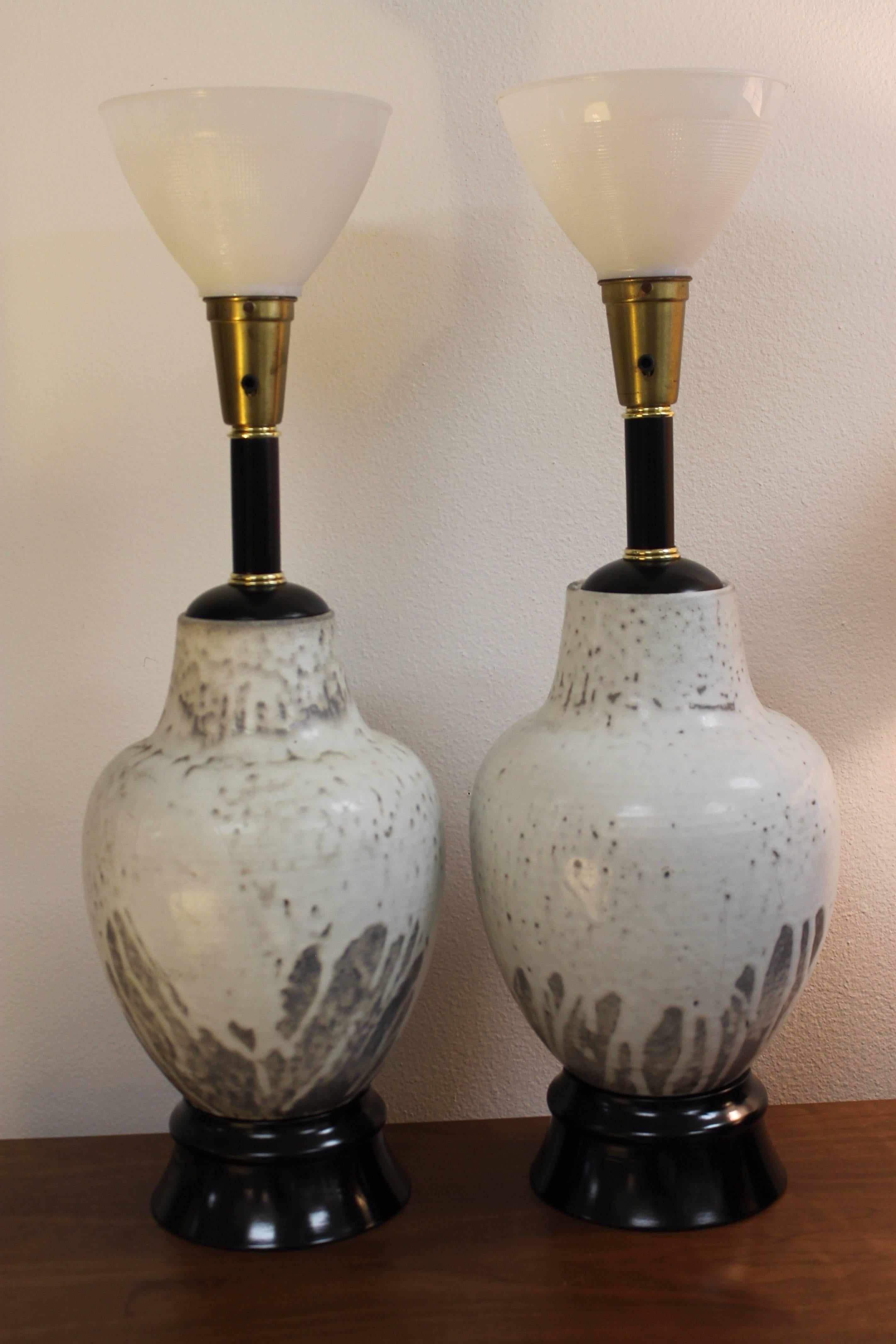 Pair of handcrafted all original stoneware lamps by Mobach, Made in Holland. Bases have been repainted and professionally rewired. We're including pictures of the ceramic portions while being rewired displaying the maker. Lamps measure 31” high from