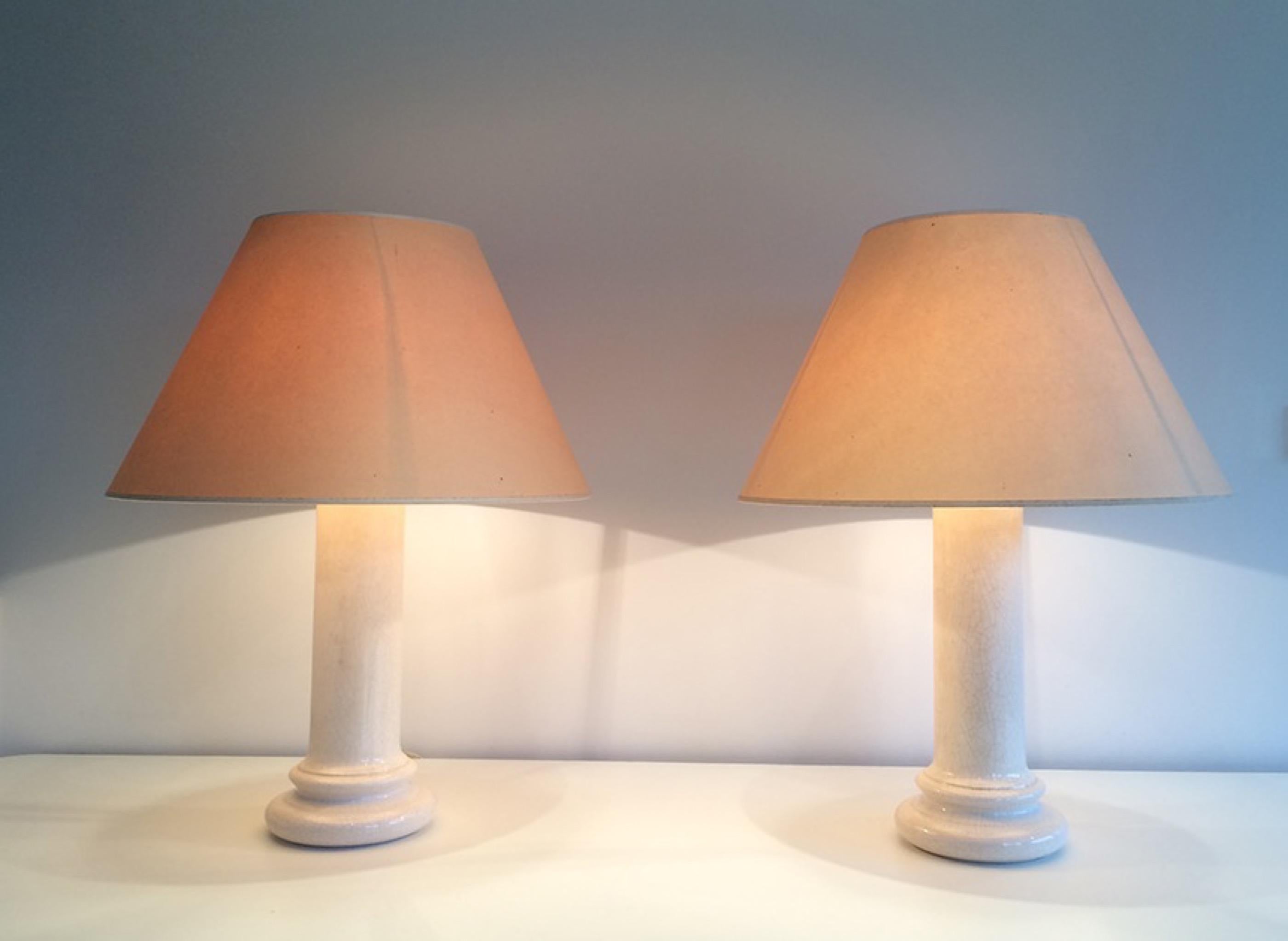 This pair of lamps is made of a white cracked earthenware. There is a very light burst on top of each lamp but something very light, almost nothing.  This is a French work, circa 1970.