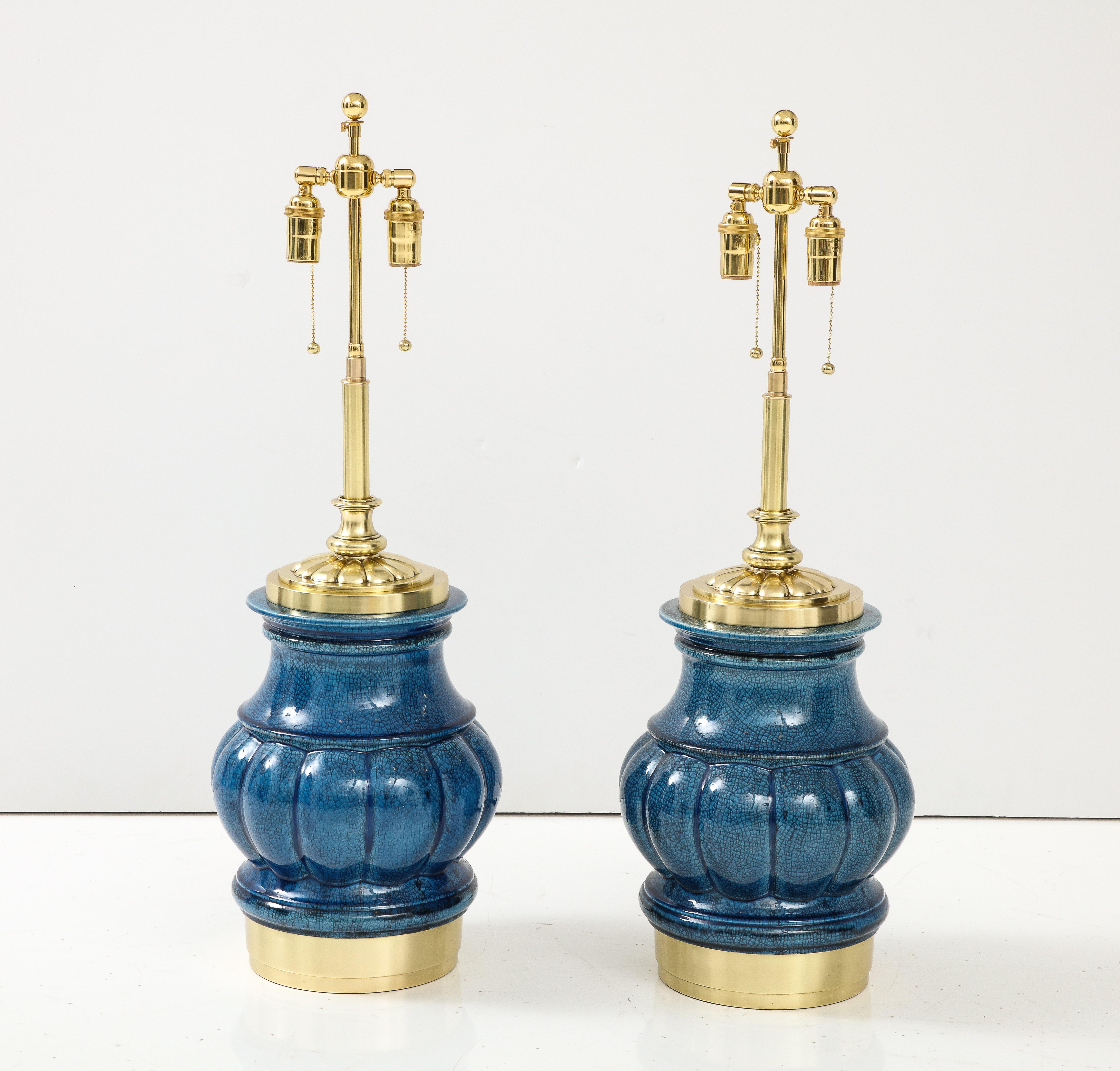 Pair of large ceramic lamps with a beautiful crackle glazed finish by Stiffel lamp company.
The lamps sit on Polished brass bases and they have been Newly rewired with adjustable polished brass double clusters and silk rayon cords.
The lamps take