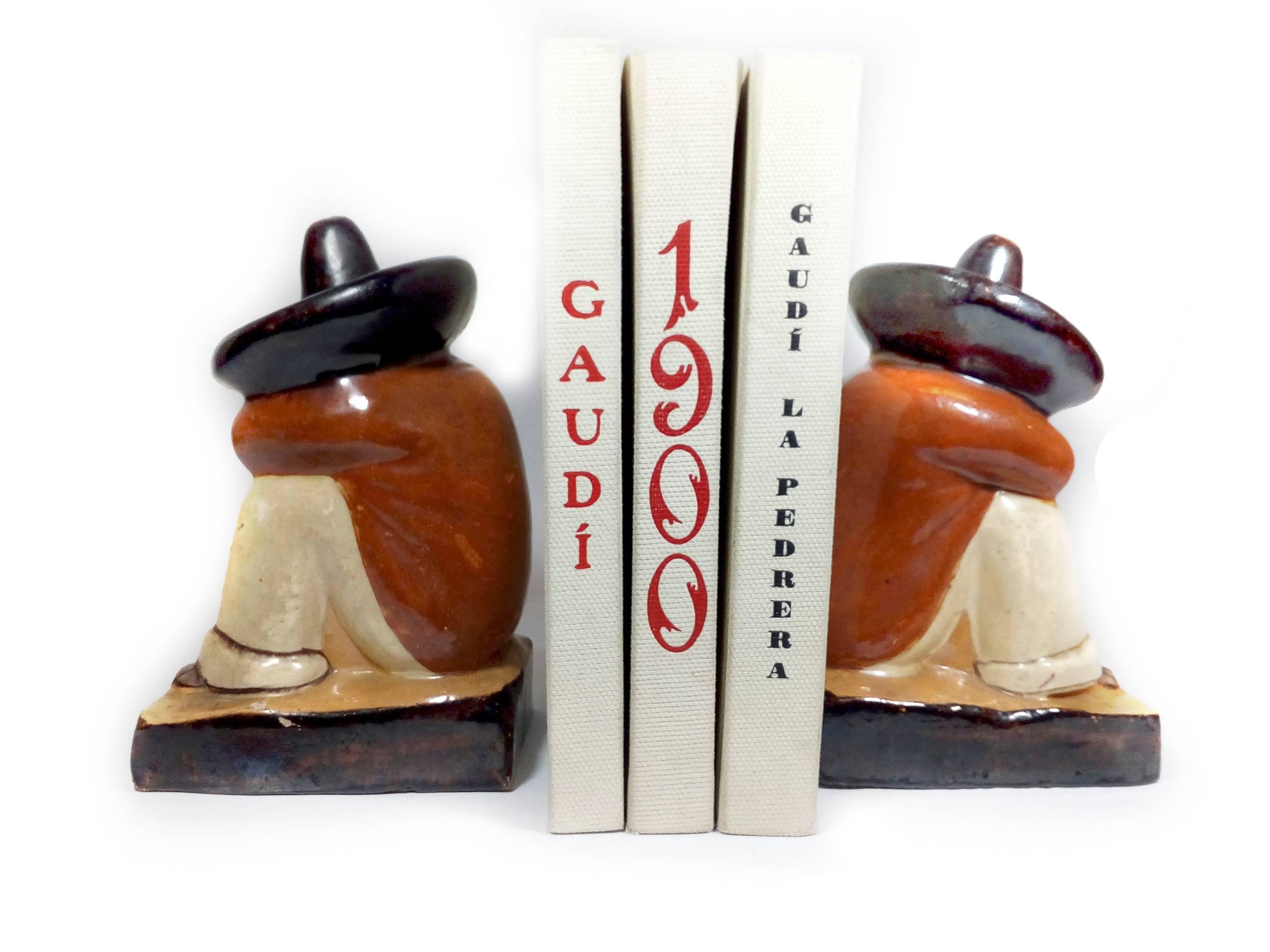 Pair of whimsical pottery bookends, made in Tlaquepaque, Jalisco, Mexico probably in the 1950s. The figures depict two sleeping men with large sombreros, hand painted in glazed colors. Tlaquepaque and Tonalá (both in the state of Jalisco) are two