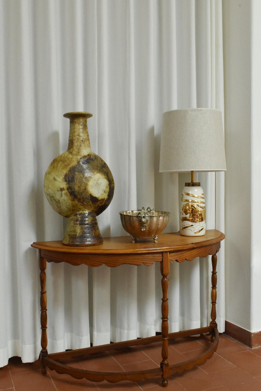 Pair of neoclassical white ceramic lamps with a golden mythologic pattern representing a female and a male gods. Portugal, 1940s
