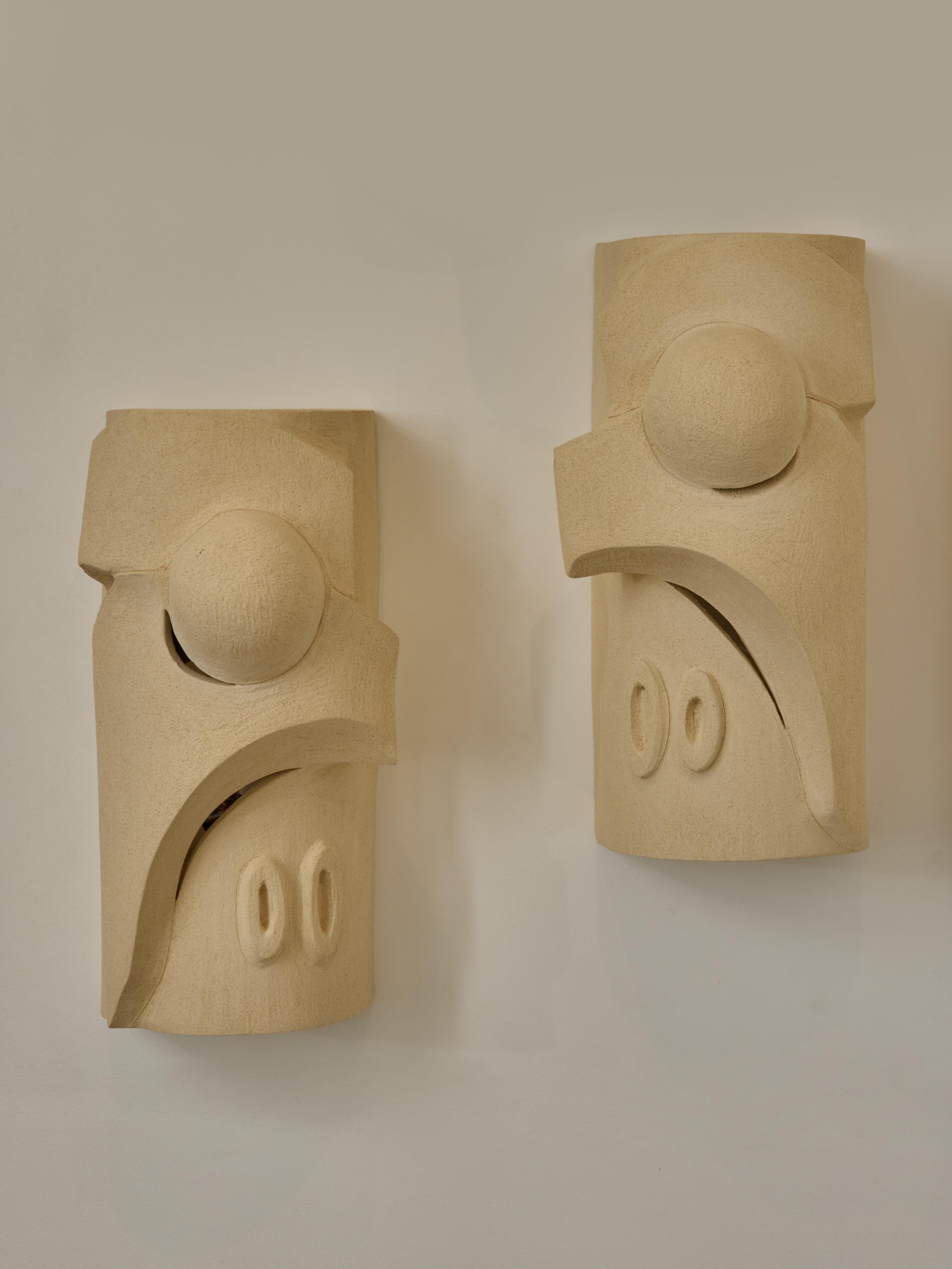 Pair of symmetrical ceramic wall sconces by Olivia Cognet, made in Vallauris, France.

Single piece of ceramic without electrical component, made to be installed n front of a source of light.

Since moving to Los Angeles in 2016, French artist and