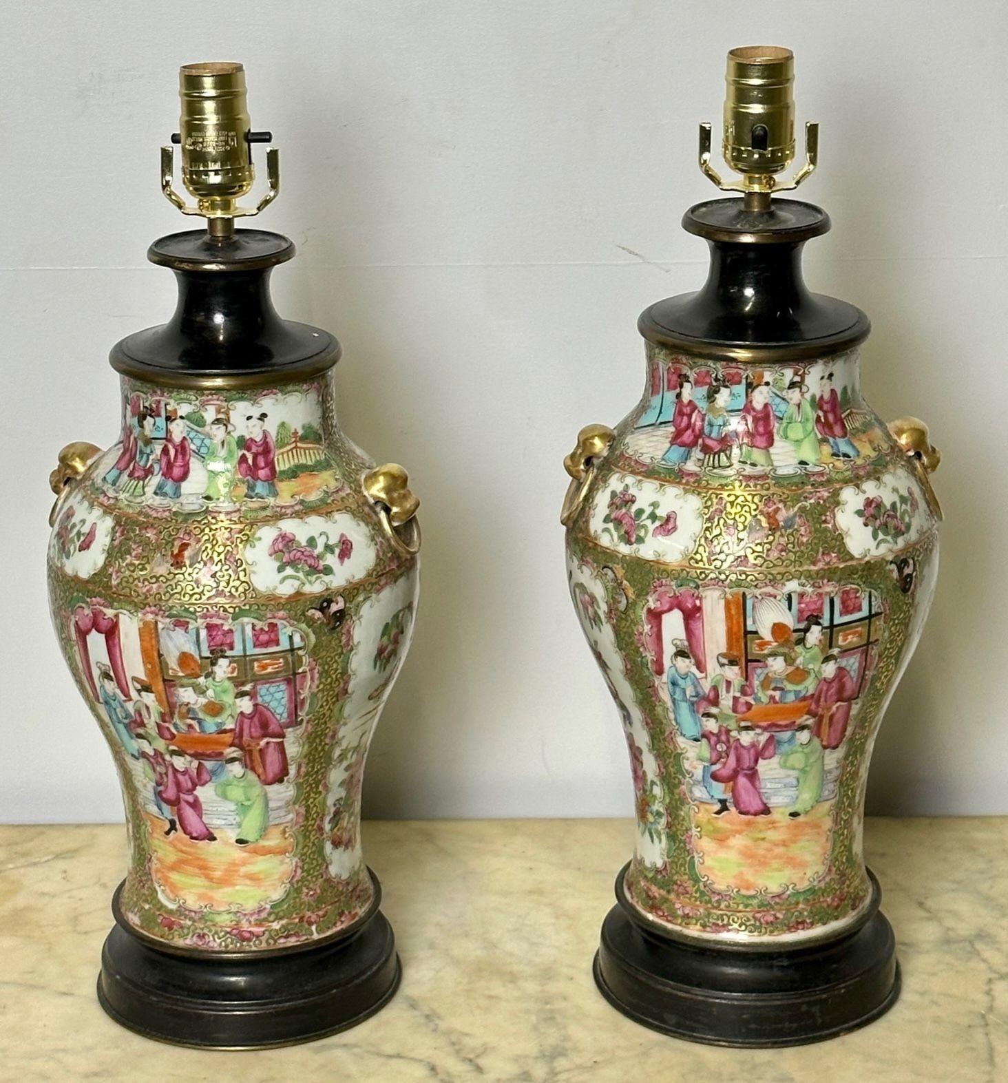 Pair of Ceramic Oriental Table Lamps, Decoration, Bronze, 19th C.
A fine pair of porcelain vase style table lamps depicting gathered figures in addition to floral and animal motifs.  Each is further ornamented with a pair of foo dog handles and a