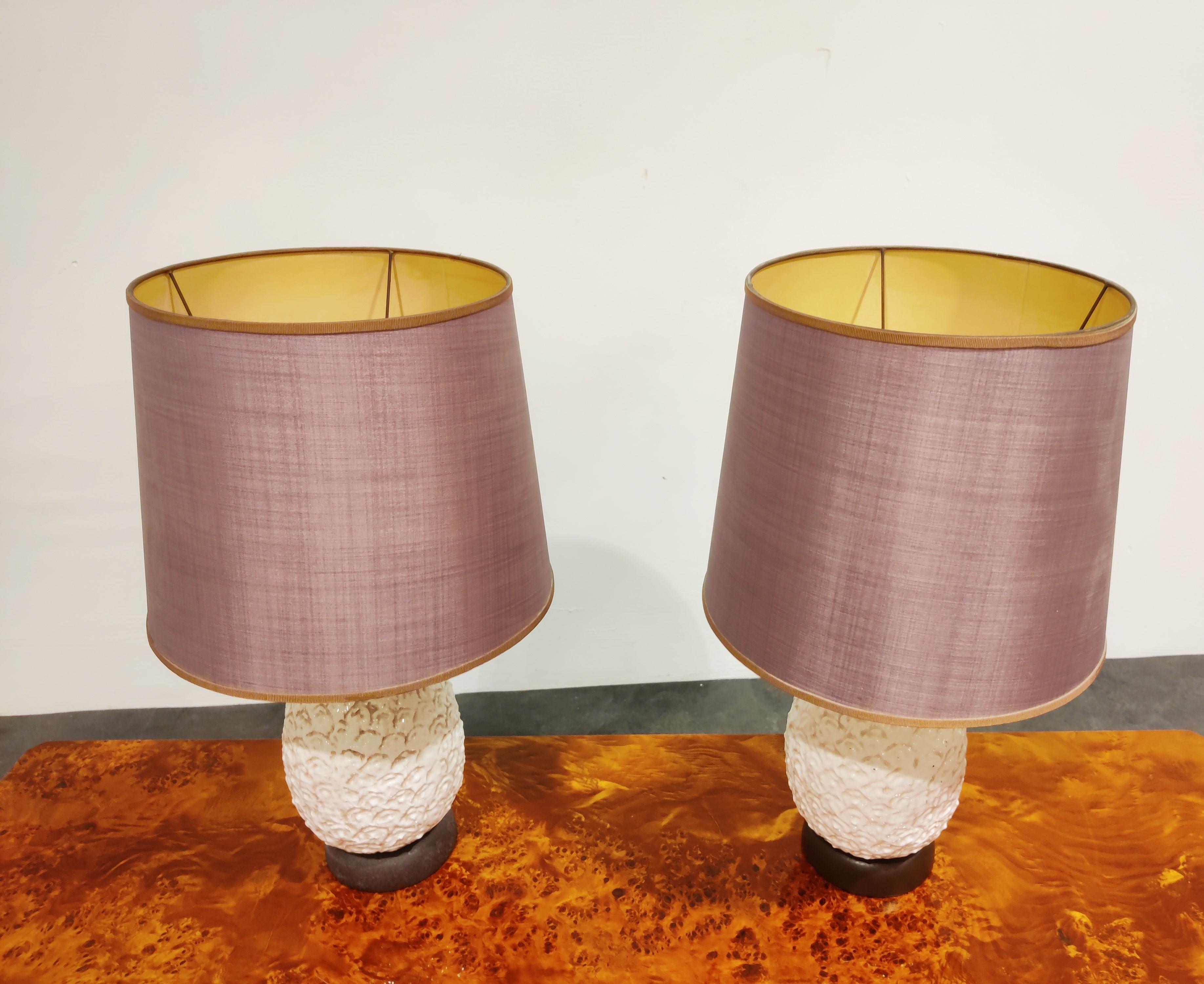 Pair of charming midcentury ceramic pineapple table lamps.

These beautiful handmade lamps come with their original purple lamp shades which give a soft light.

Good, tested and ready to use with a regular E27 light bulb.

Brown traces on the