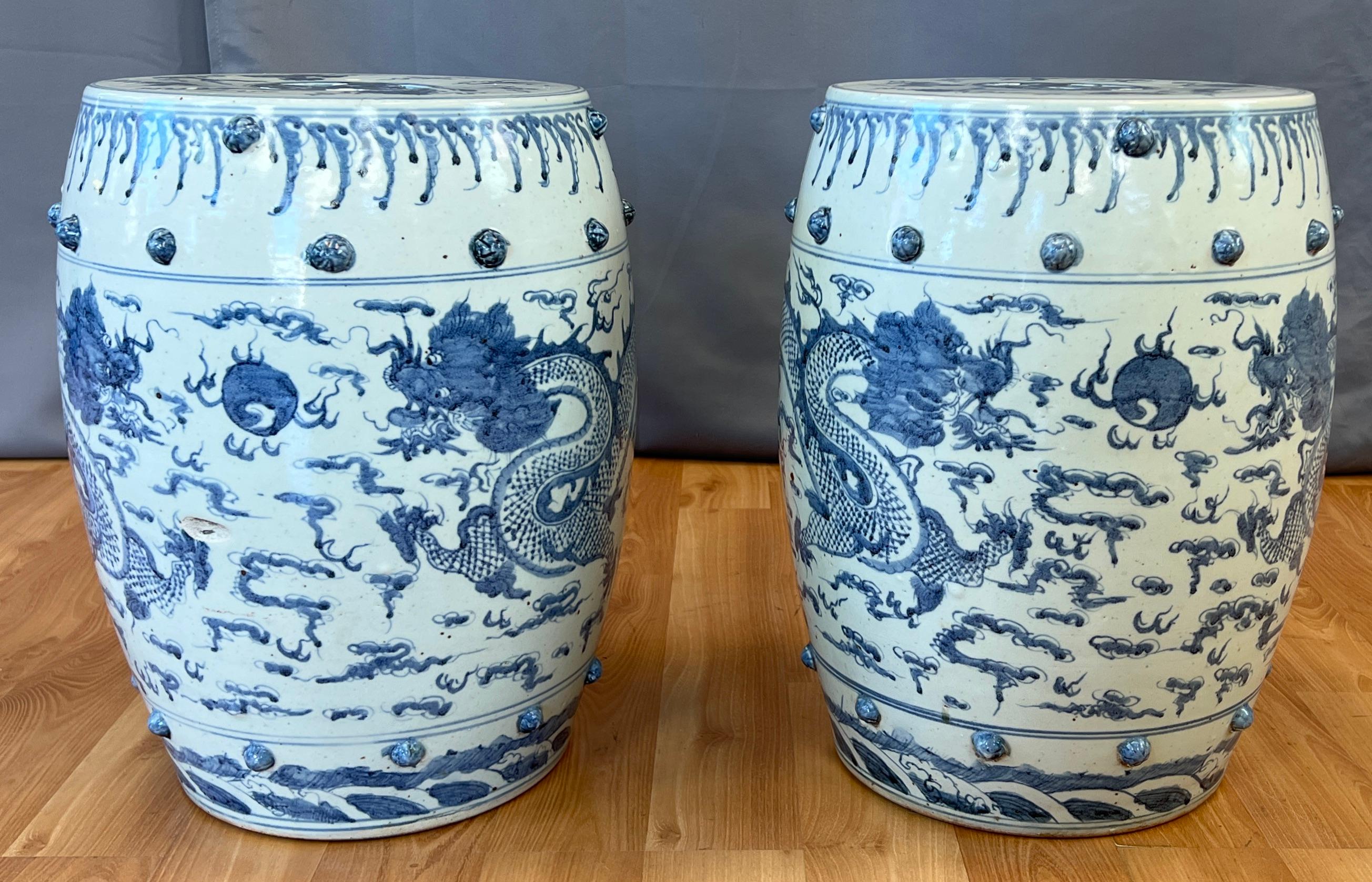 Offered here are a pair of ceramic garden stools, circa 19th century.
Both have a pair of hand painted Blue Dragons design around their sides, sets of raised nubs near their tops and bottoms, then there's the pierced tops of both stools.