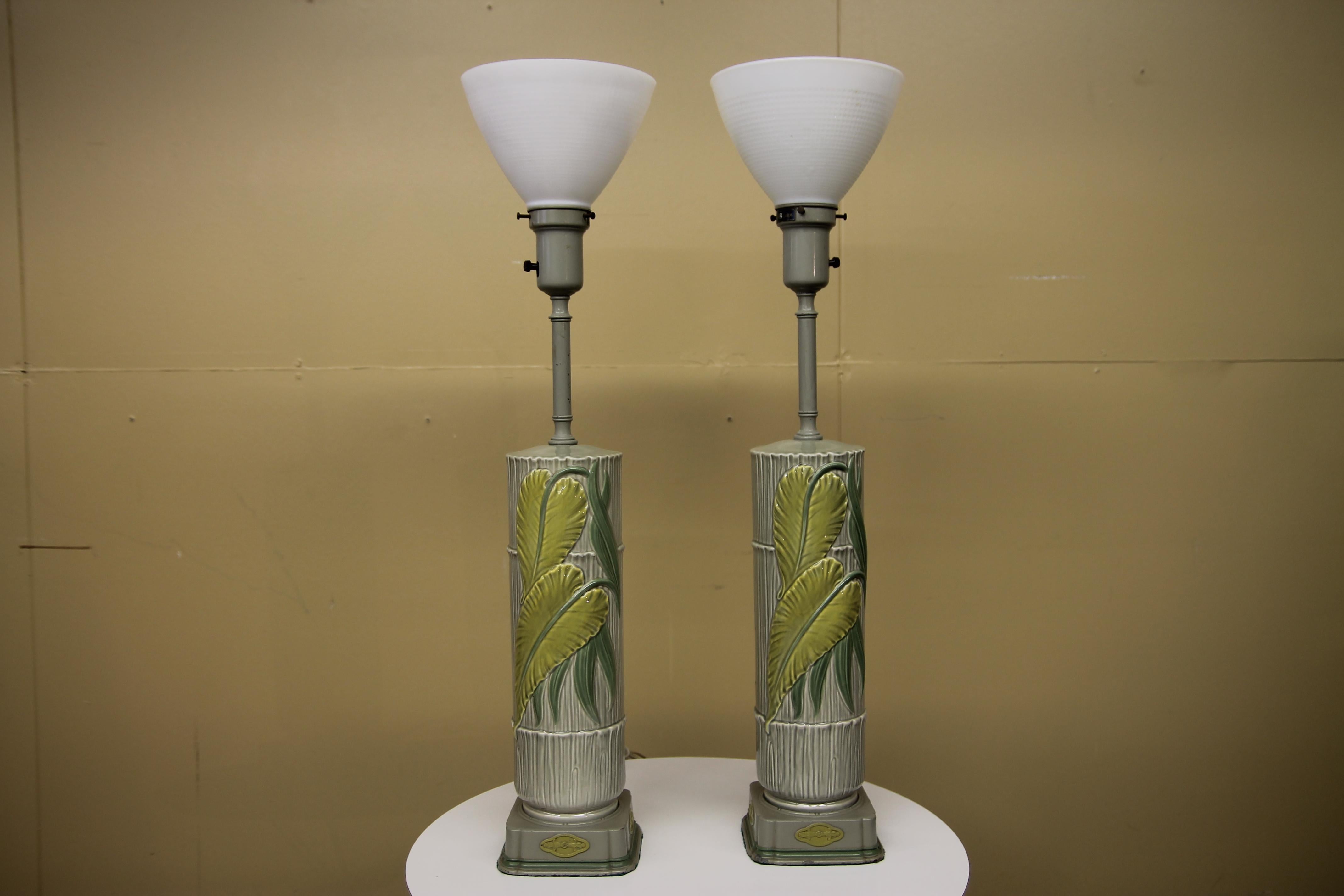 Wonderful pair of Rembrandt table lamps in amazing original condition. These 1950s ceramic lamps have a great tropical feel to them with the look of bamboo and raised leaves. I have not found this example for sale on any sites.