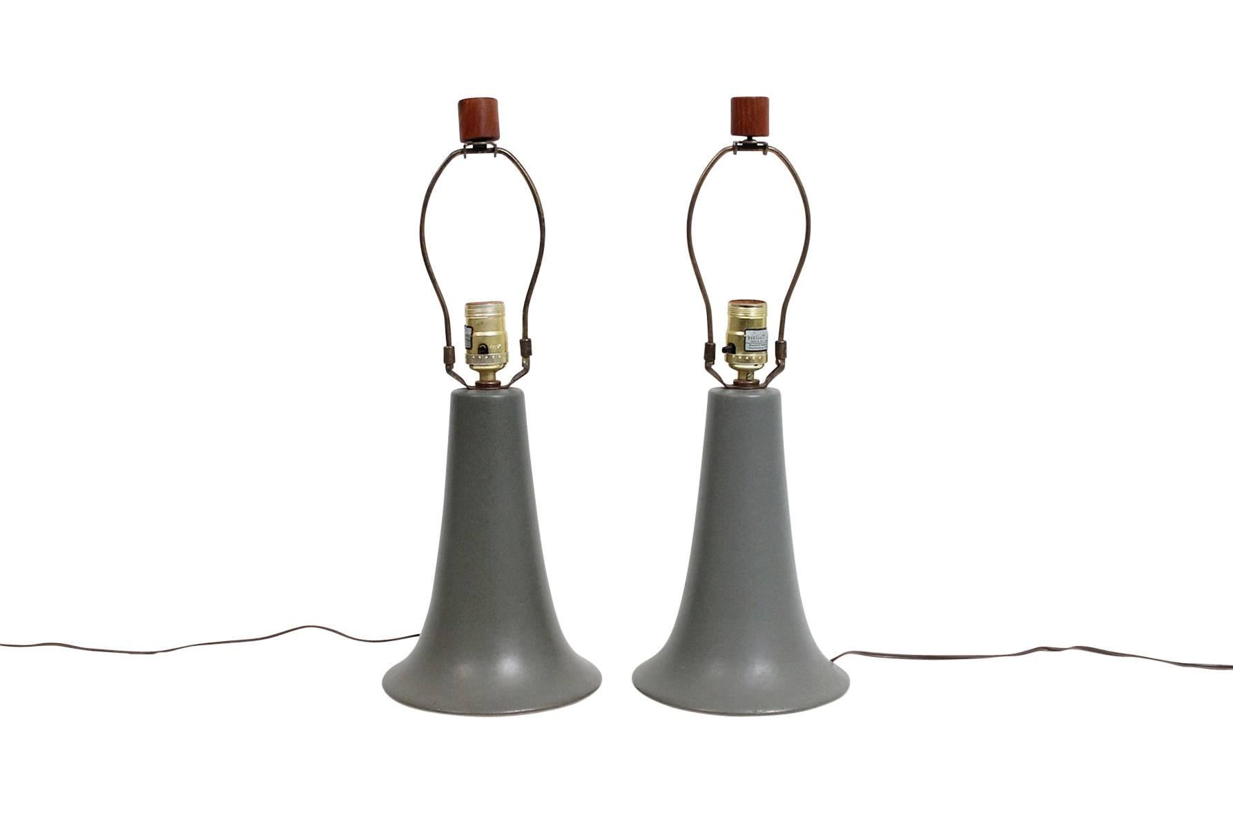 Table lamps by Jane and Gordon Martz for Marshall Studios. Green matte glaze on bell shaped ceramic bases and iconic wooden finials. Both lamps signed. Dimensions below are for lamp with shade pictured. Dimensions of lamp body: Height 10