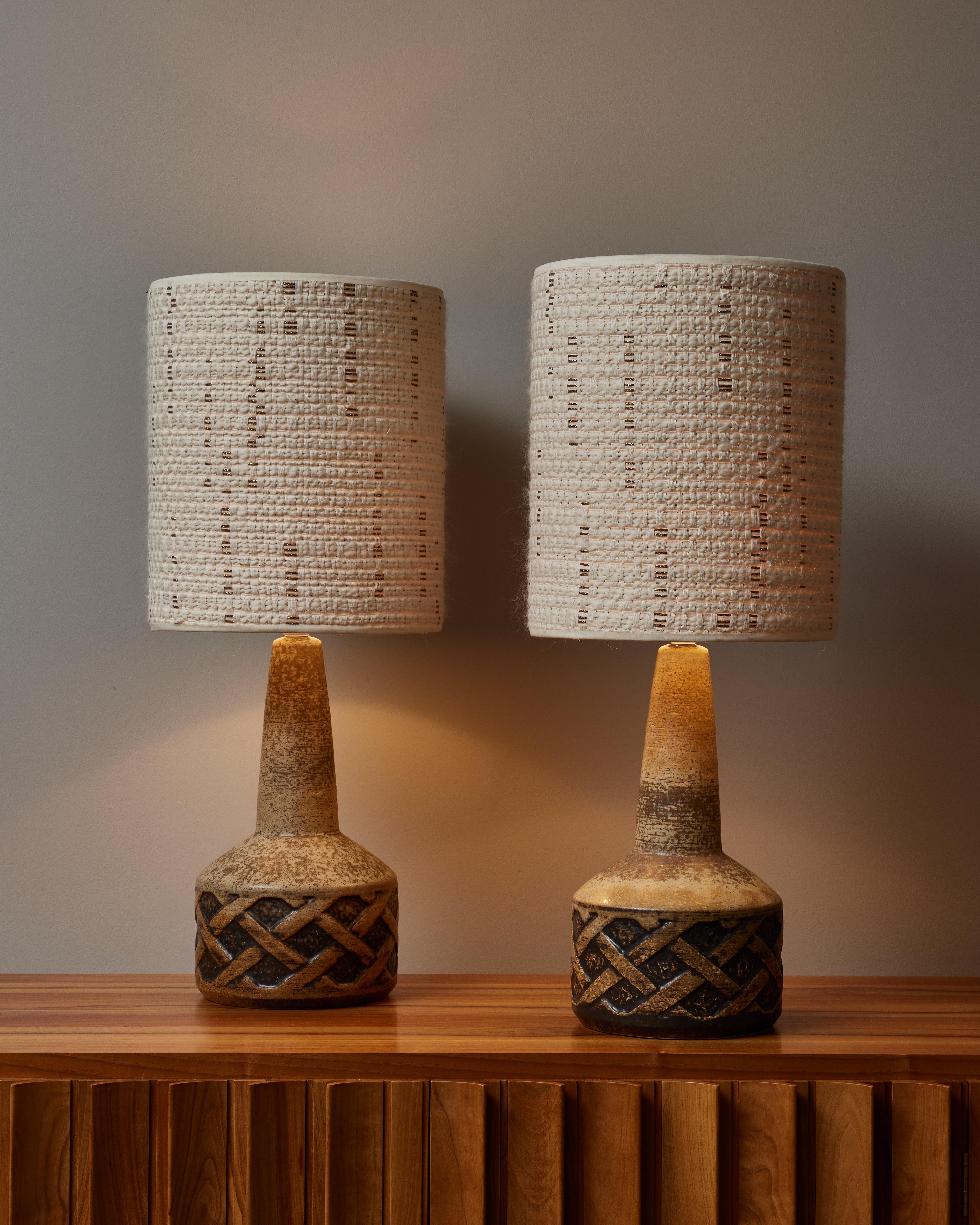 Pair of table lamps made of ceramic with a textured twisted motif by the makers from Søholm Stentøj. New lampshades with fabric from Dedar.

The origin of Søholm Stentøj (Soholm’s sandstone) dates back to the first half of the 17th century and the