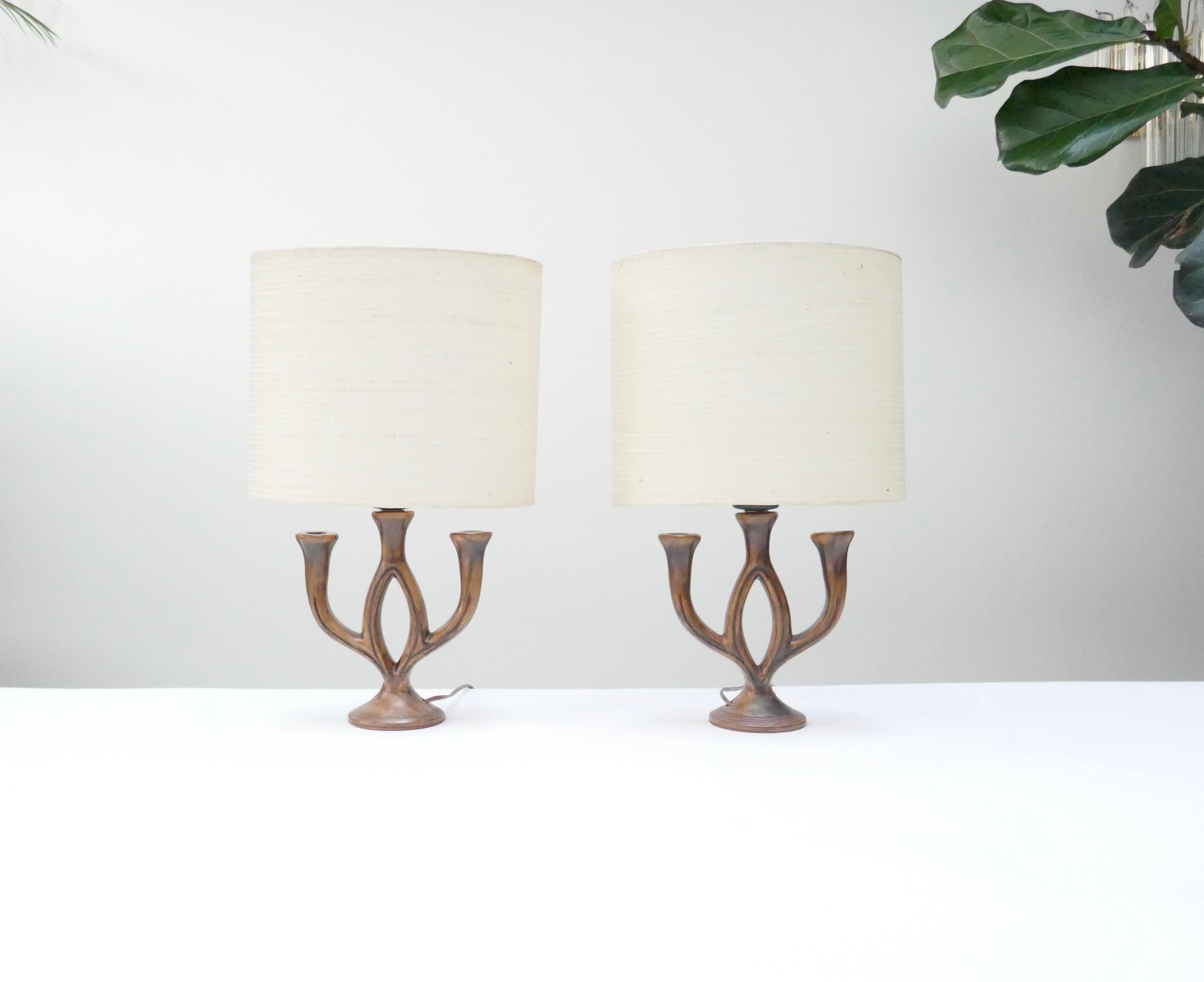 2 well sized brown table lamps in ceramics signed Les Grottes Dieulefit.
Originally candleholders wired as a table lamps. 
They are painted wood like with Matt finish.

They are the work of Poterie Les Grottes in the town of Dieulefit in Drôme,
