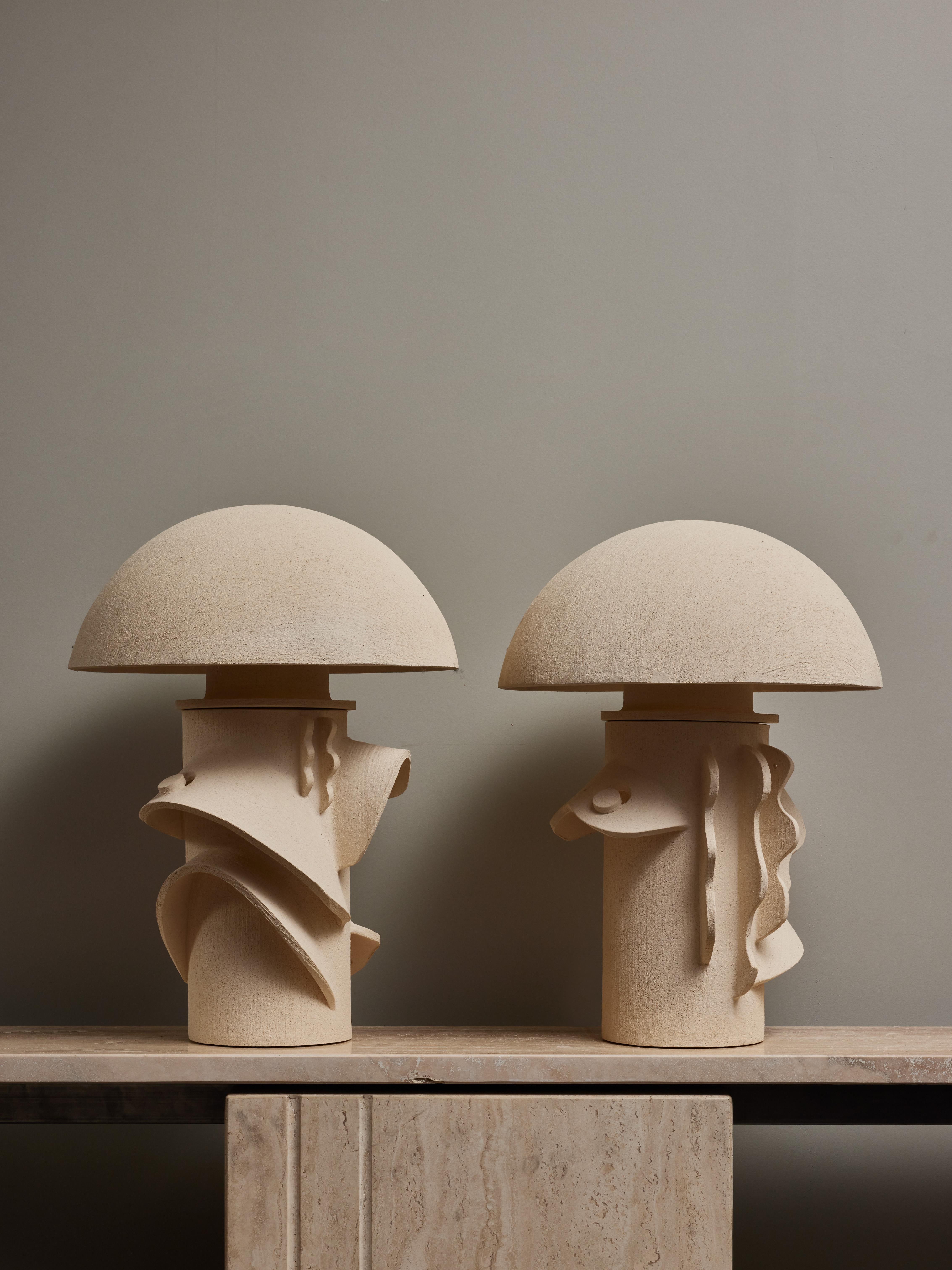 Pair of table lamps made by Olivia Cognet. Each piece is made of a large cylindrical body covered with sculpted decors and topped with a curved ceramic lampshade.

Since moving to Los Angeles in 2016, French artist and designer Olivia Cognet has