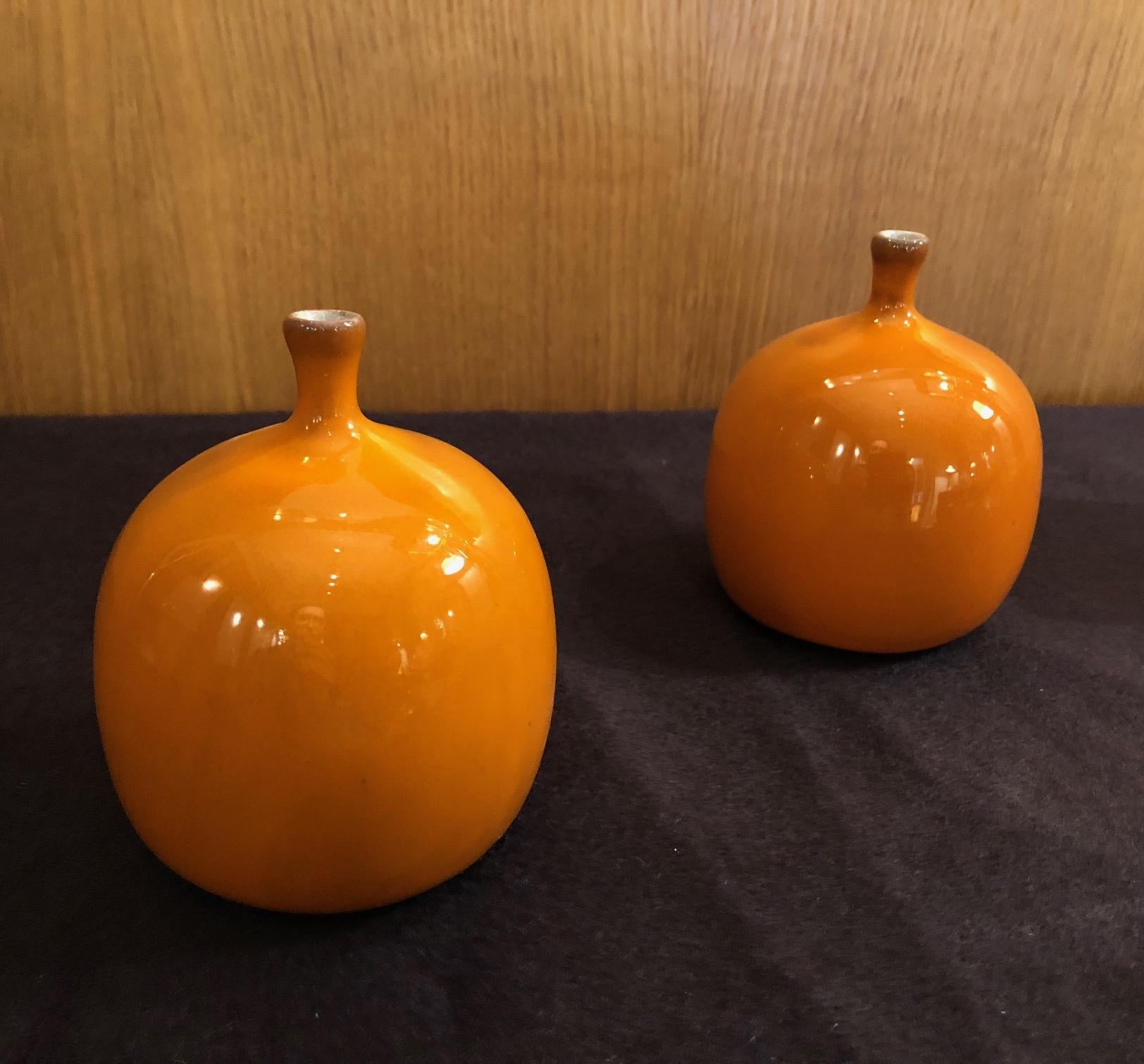 Apple form vases by the French ceramic artists Jacques and Dani Ruelland (model n°2, small one). An orange glaze. Signed.