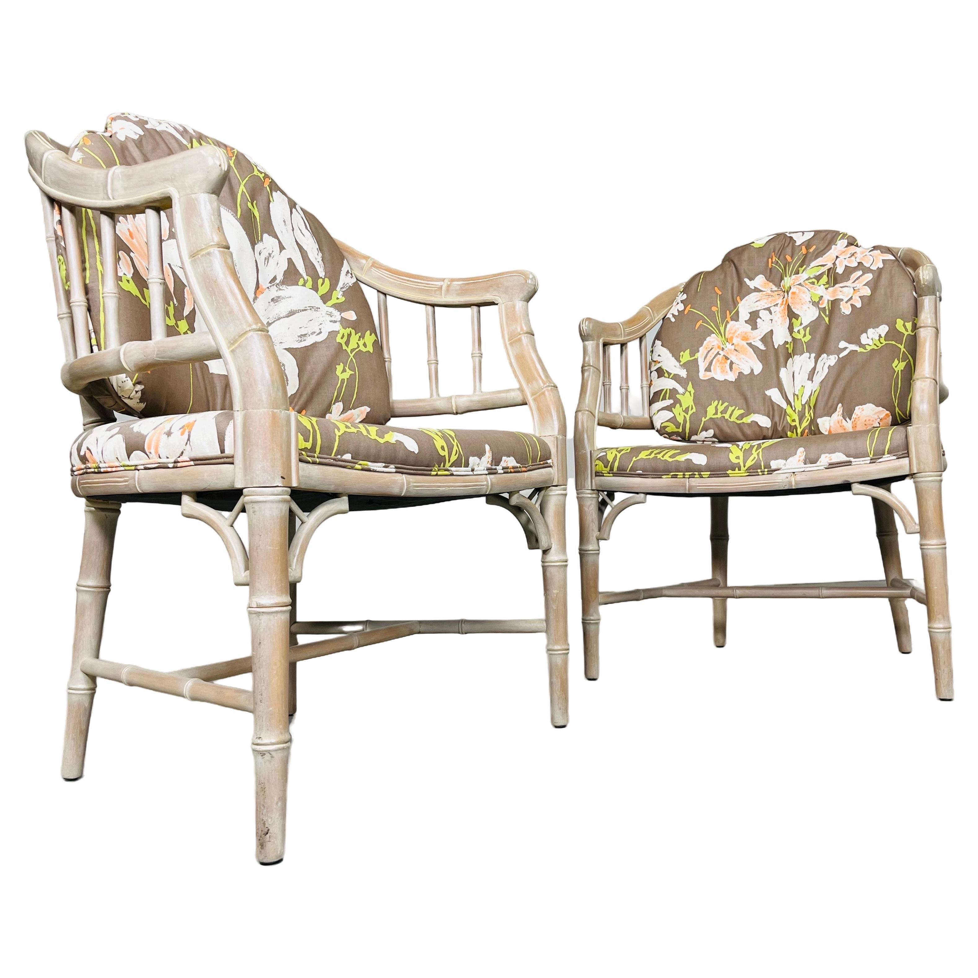 A beautiful pair of carved faux bamboo cerused easy chairs in the Chinese Chippendale style having Chinese inspired floral upholstery. In excellent condition having no damage and fresh upholstery and cushioning with internal lattice strap suspension