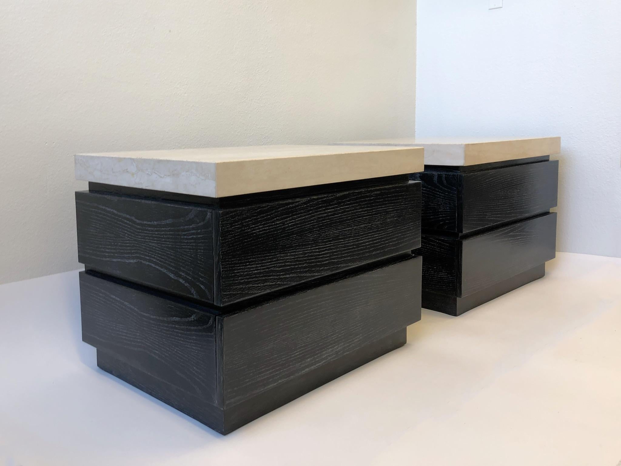 A pair of beautiful black cerused oak, two drawers nightstand with travertine tops design by Kreiss in the 1980s.
Newly professionally lacquered.
Dimension: 32” wide, 24” deep, 24” high.