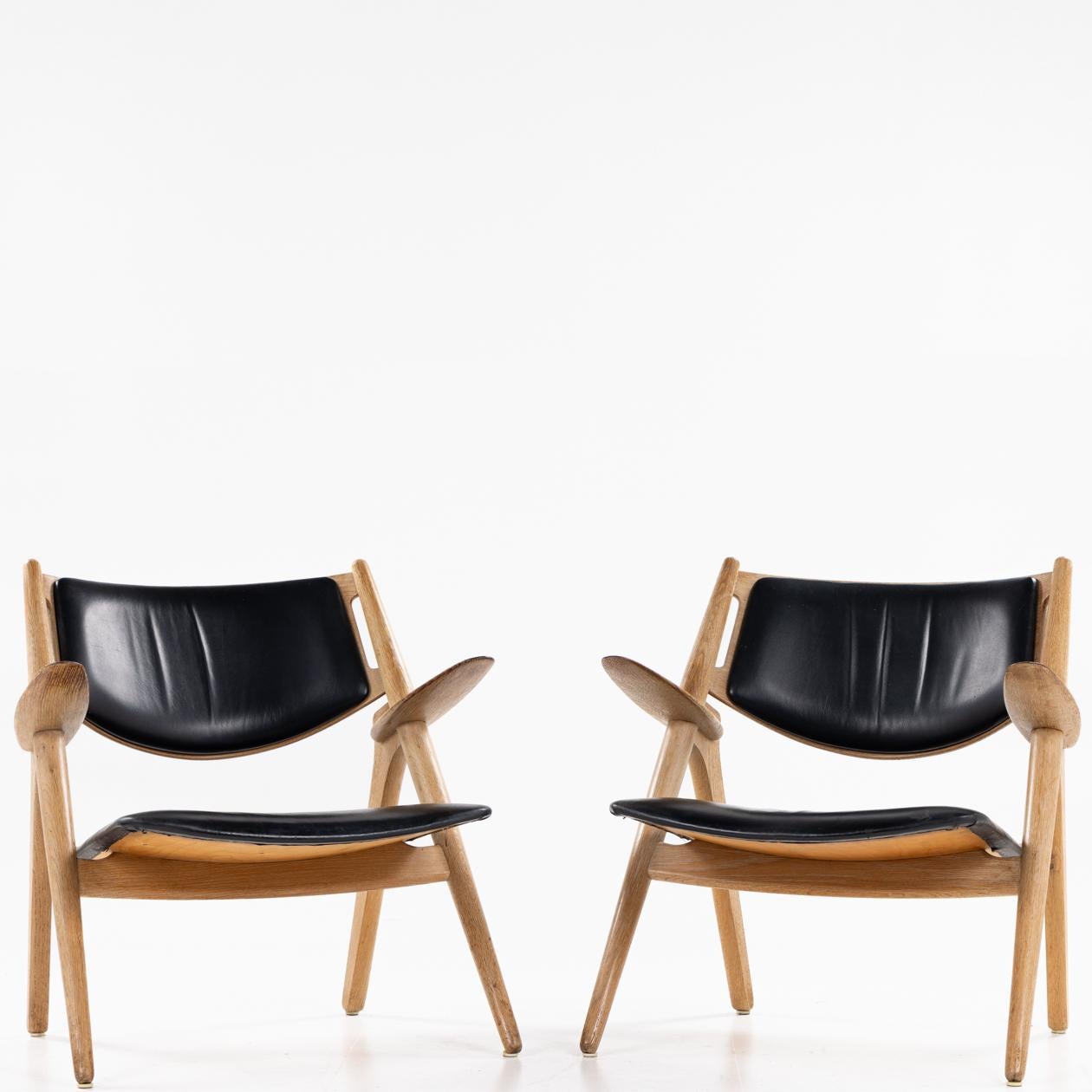 Pair of CH 28 Sawbuck easychairs by Hans J. Wegner. For Sale 1
